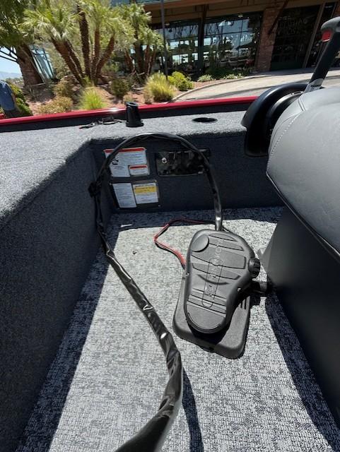 Interior of 2025 Tracker Panfish 17 boat showing foot pedal and carpeted floor.