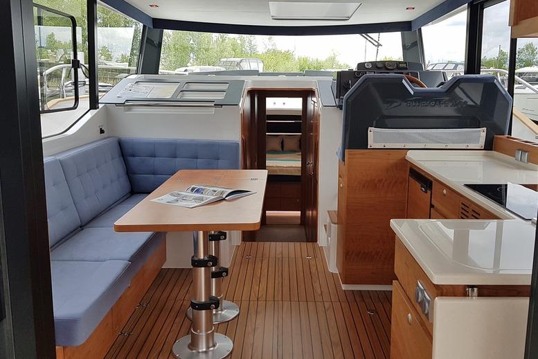 Interior of 2019 Delphia BluEscape 1200 yacht with modern seating and wooden flooring.