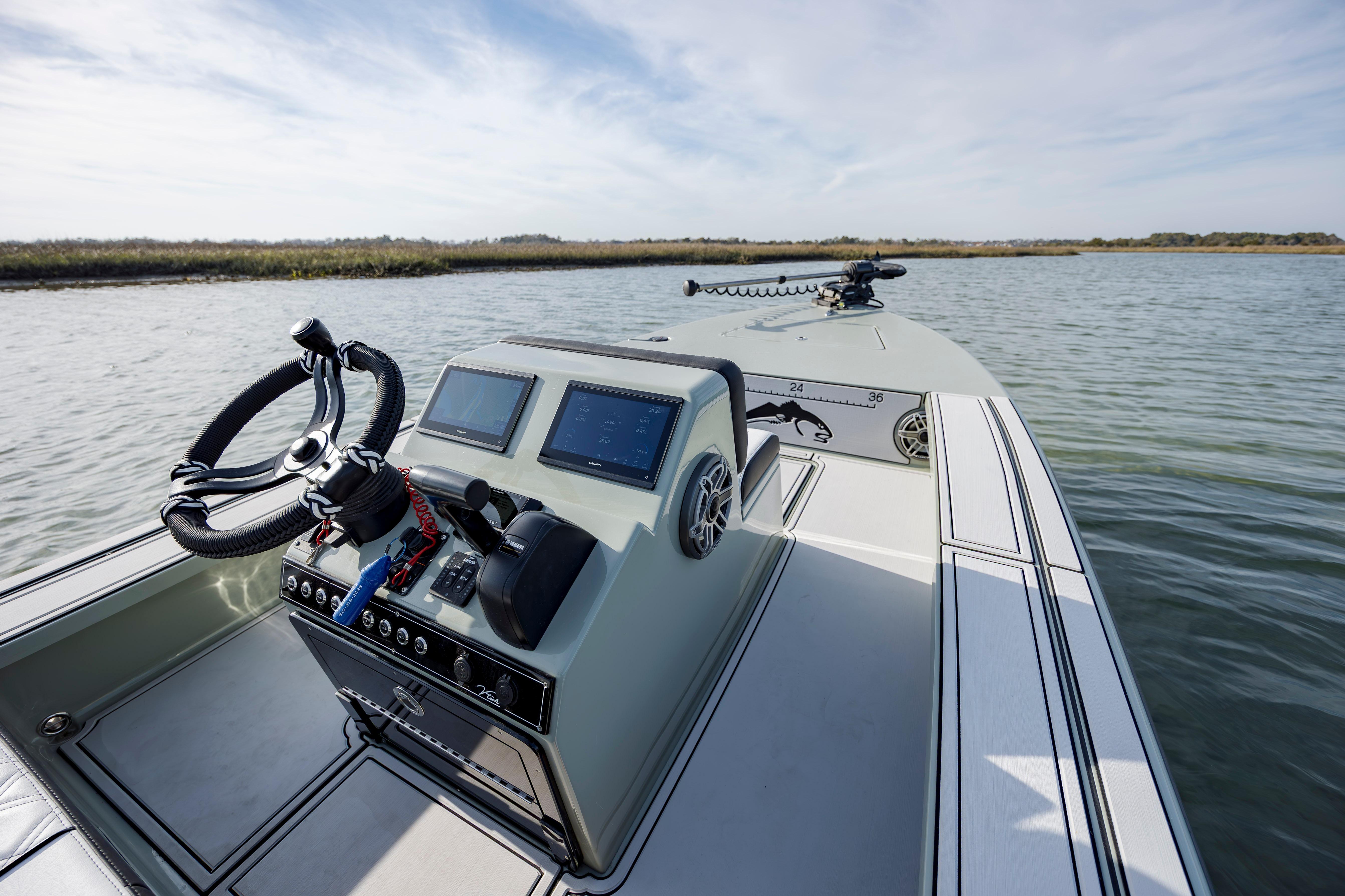 Modern Vtech 18 boat dashboard, 2025 model, on calm water with clear sky.