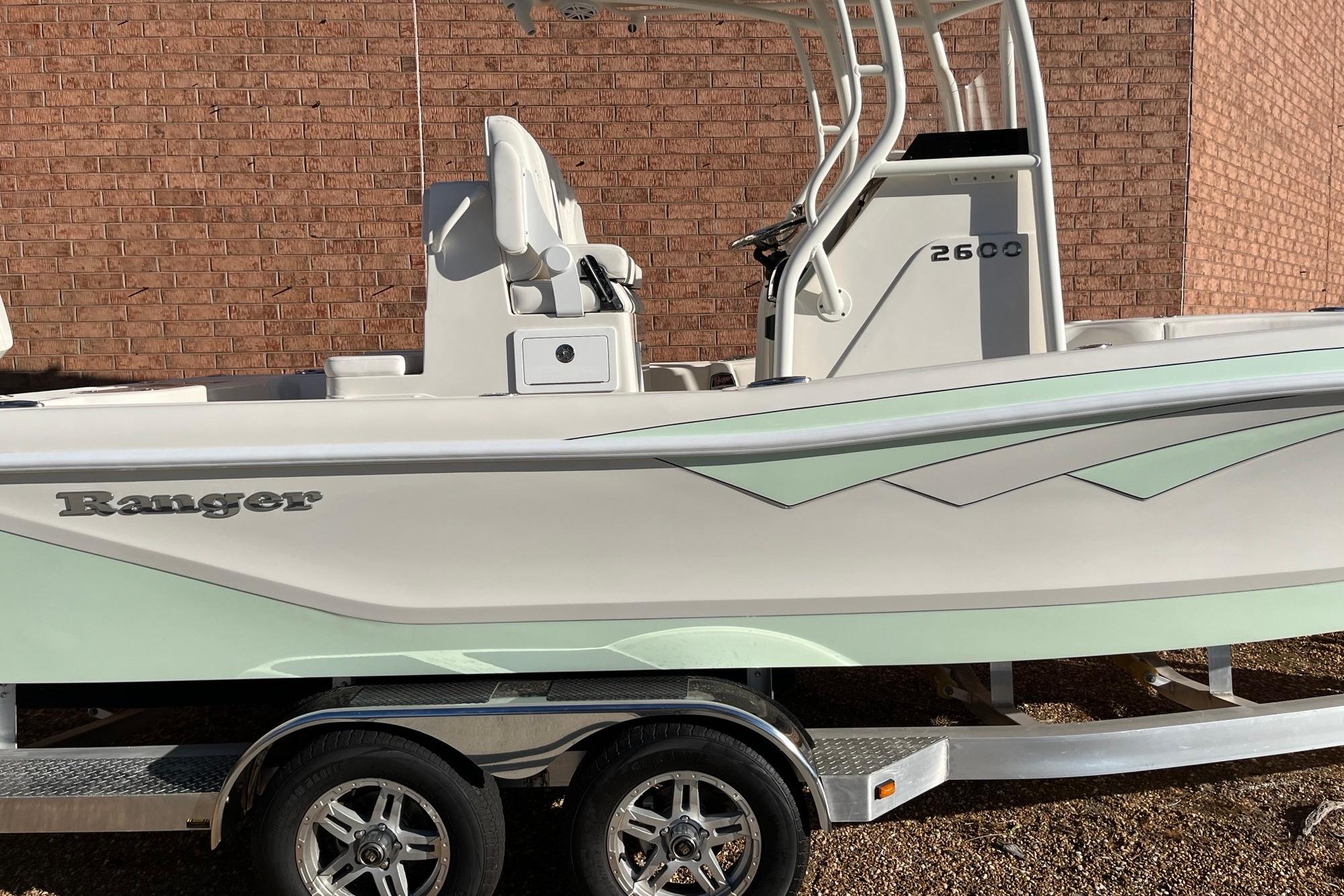 2024 Ranger 2600 Bay boat on trailer, side view, against brick wall.
