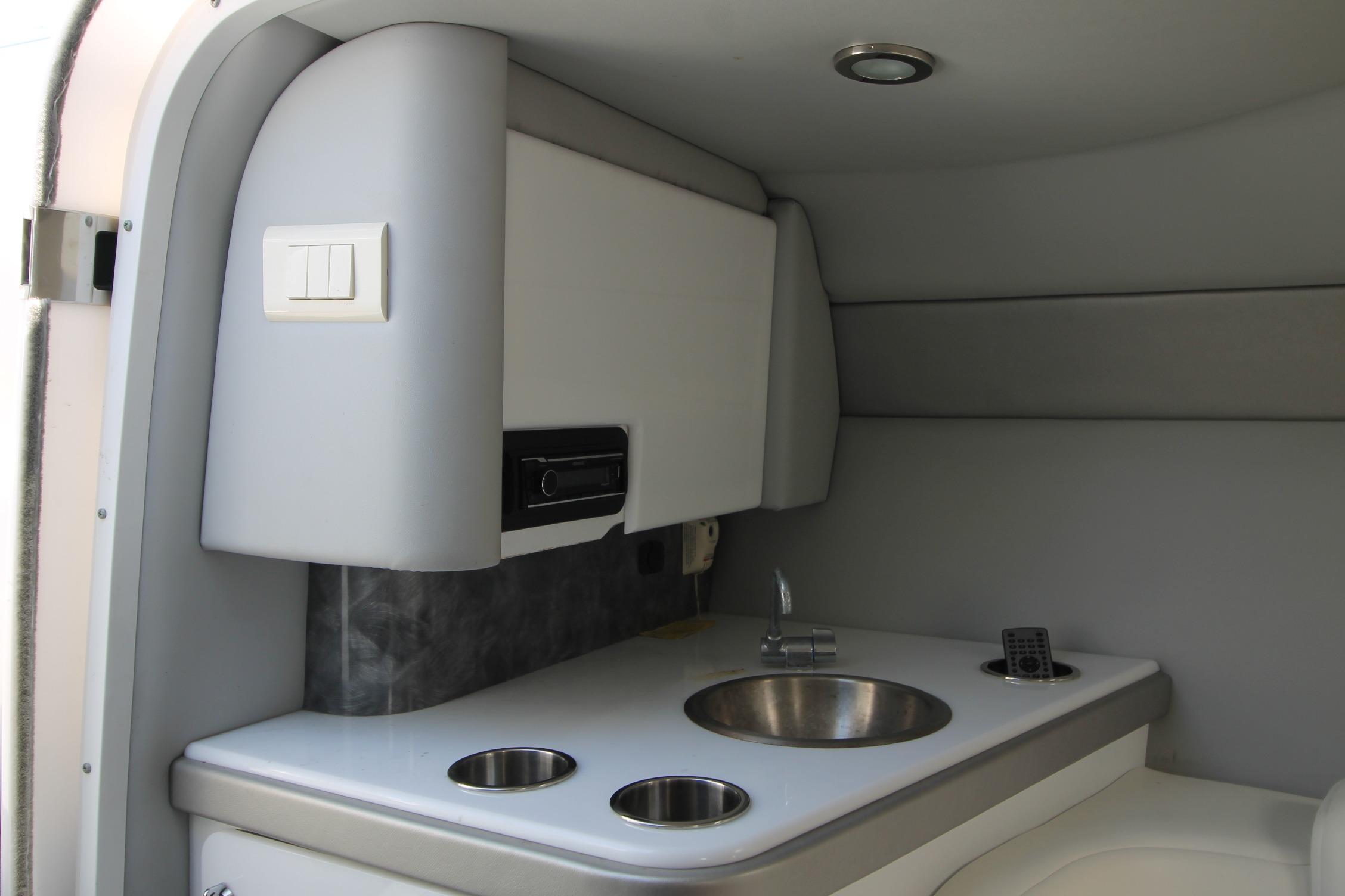 2006 Formula 292 FASTech cabin interior with sink and storage.