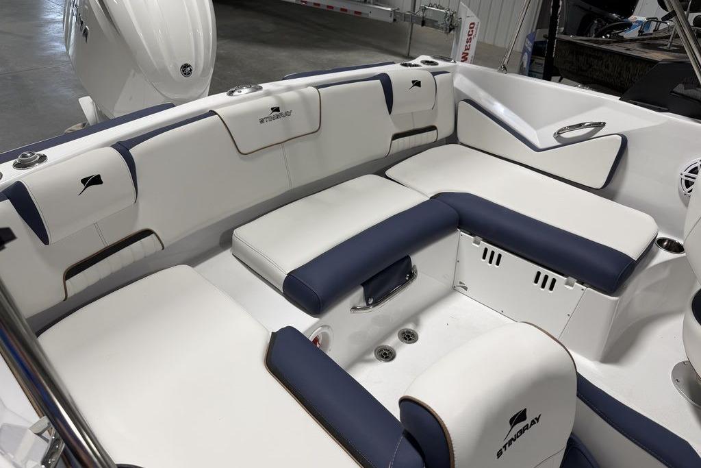 2027 Stingray 20 SBX boat interior with white and navy seating in a showroom.