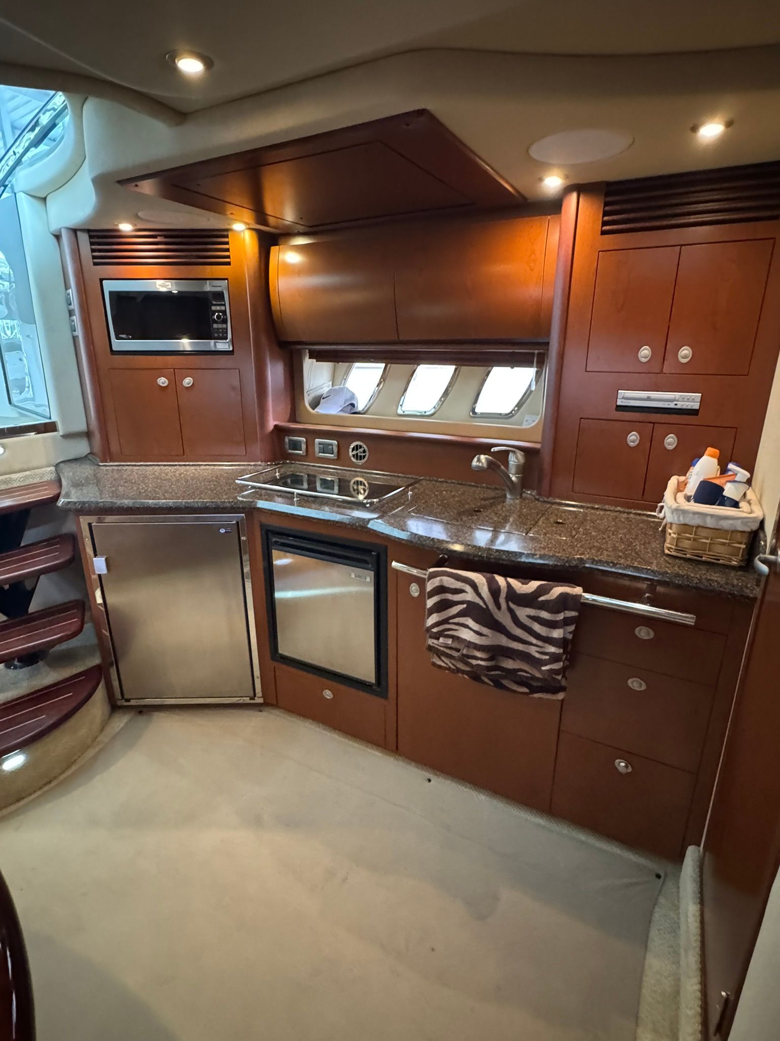 The galley of a 2007 Sea Ray 40 Sundancer with wood cabinets and modern appliances.