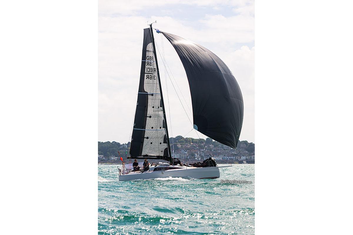 2022 Dehler 30 one design sailboat with black sails on open water.