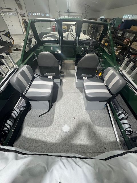 Interior of a 2023 Hewescraft 180 Sportsman boat with four seats.