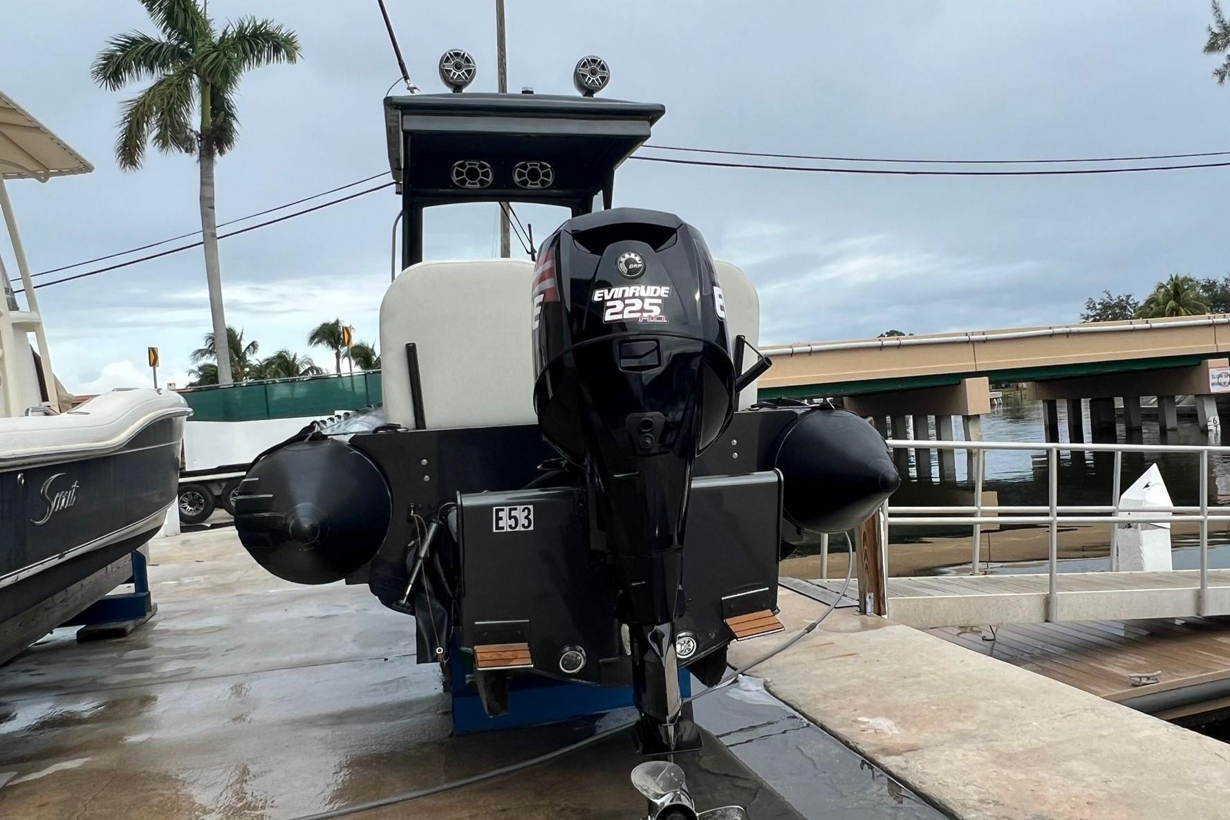 2014 Zodiac Milpro Hurricane Custom boat with Evinrude 225 HP engine at dock.