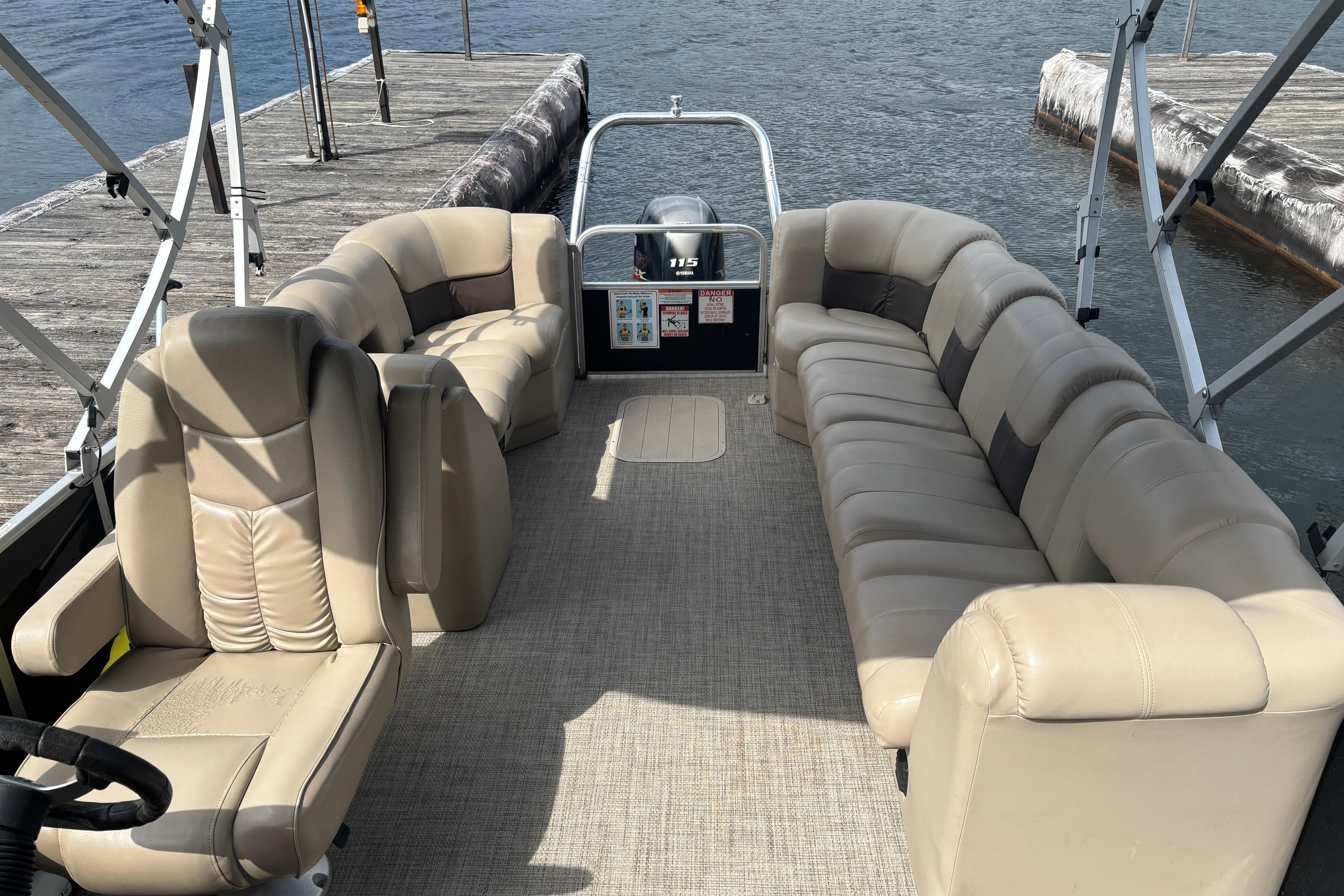 2021 SunCatcher Fusion 325RCX pontoon boat with beige seating at a dock.