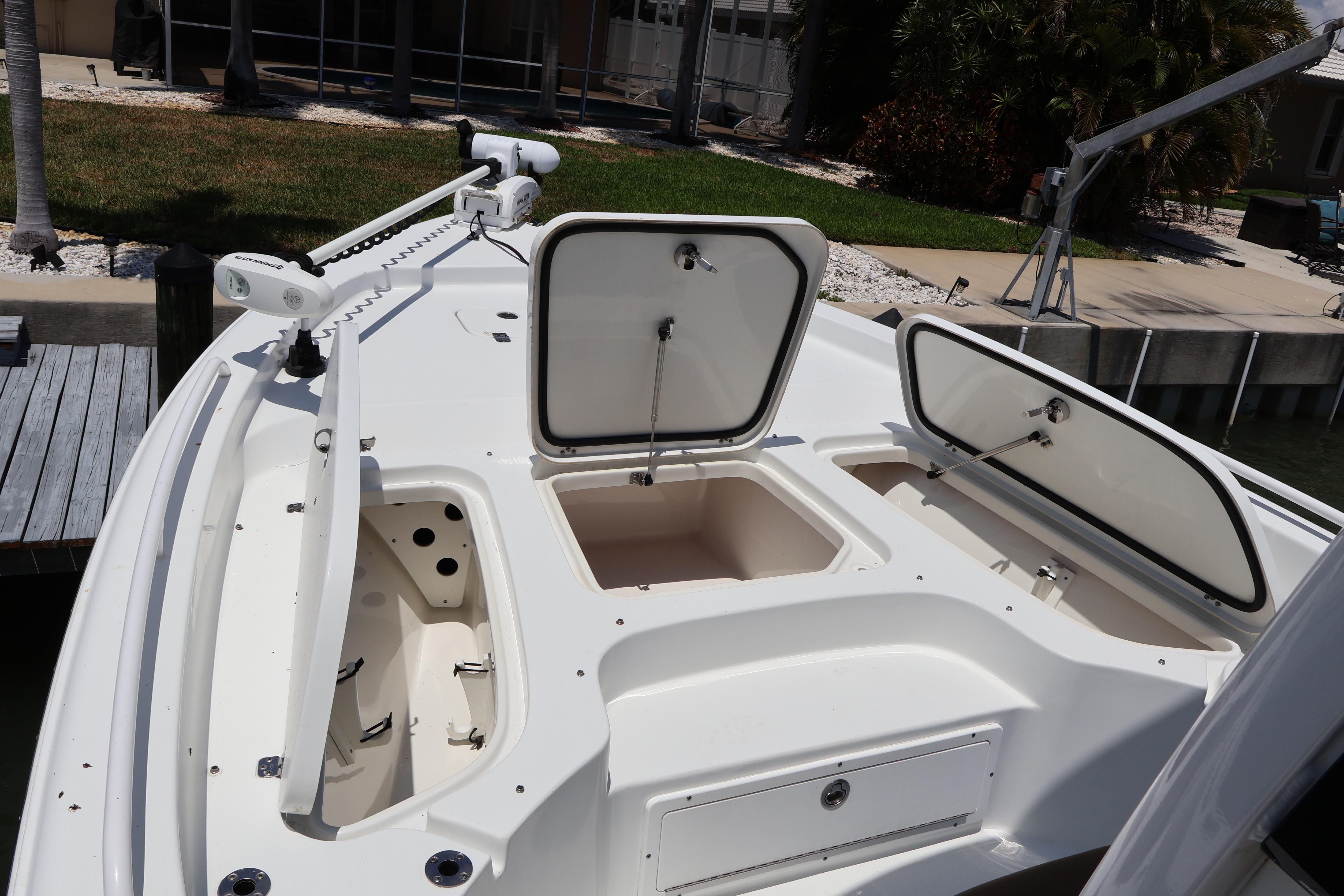 2022 Sea Hunt BX 25 FS boat with open storage compartments and trolling motor.