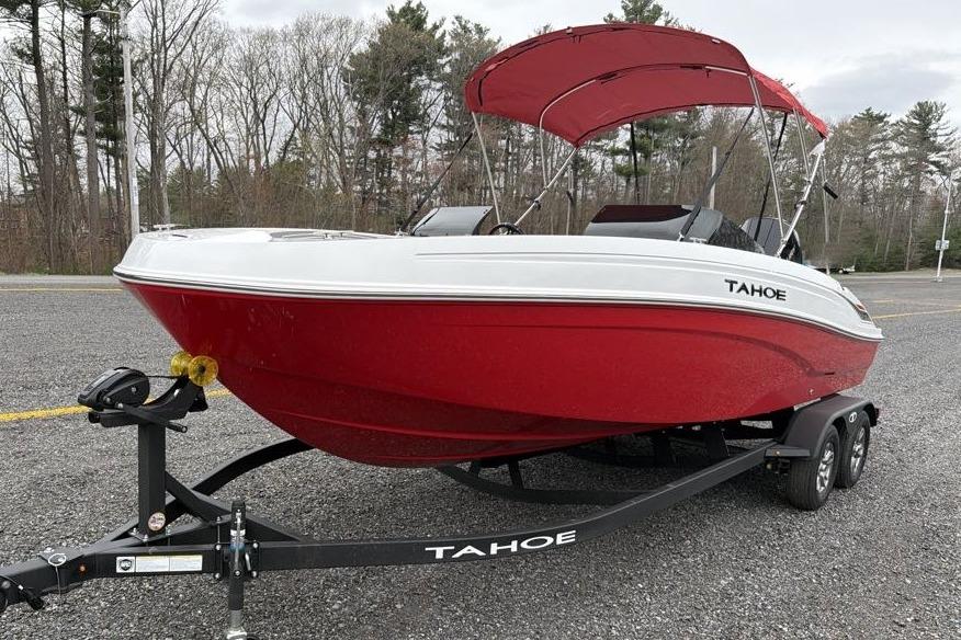 2026 Tahoe T21 boat with red hull on trailer in outdoor setting.