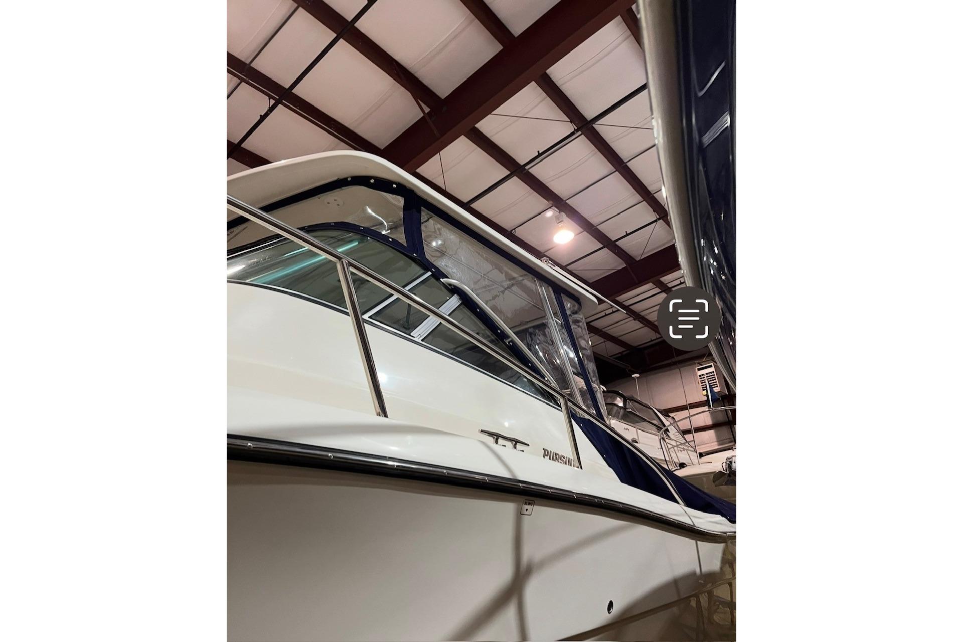 2000 Pursuit 3070 Offshore Center Console boat in indoor storage facility.