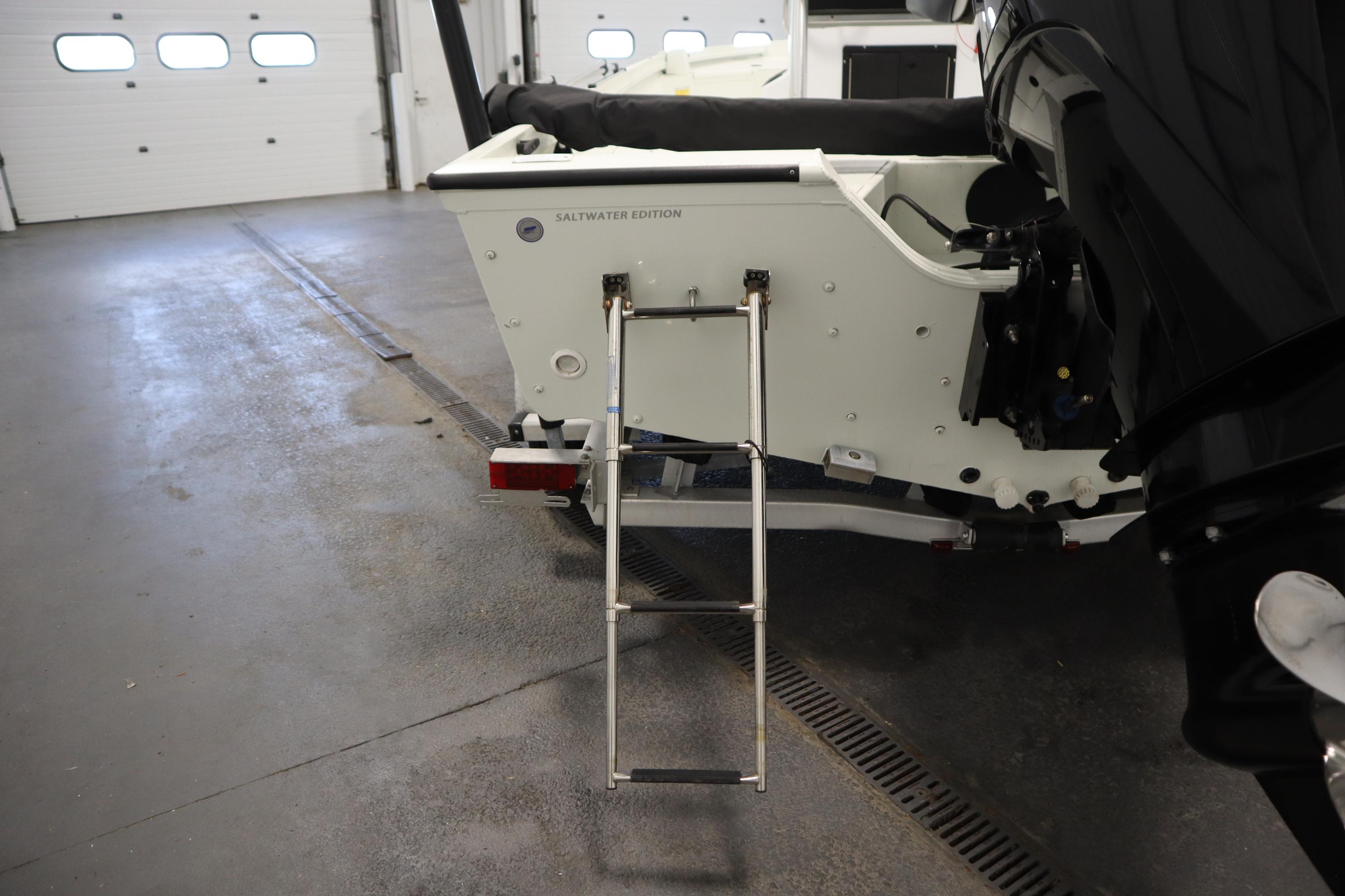 2022 Crestliner 2200 CC Saltwater Edition boat with ladder in a garage.