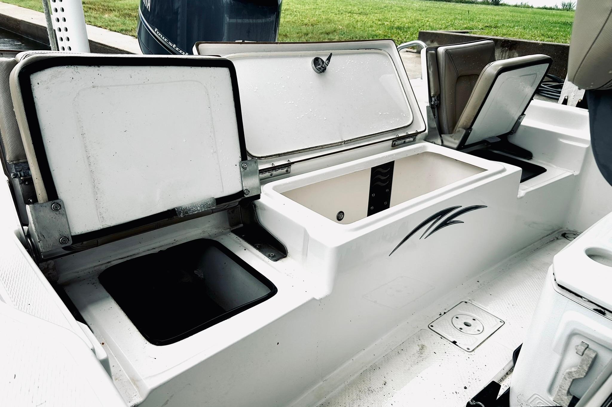 2017 Blue Wave 2200 PureBay boat with open storage compartments and seating.