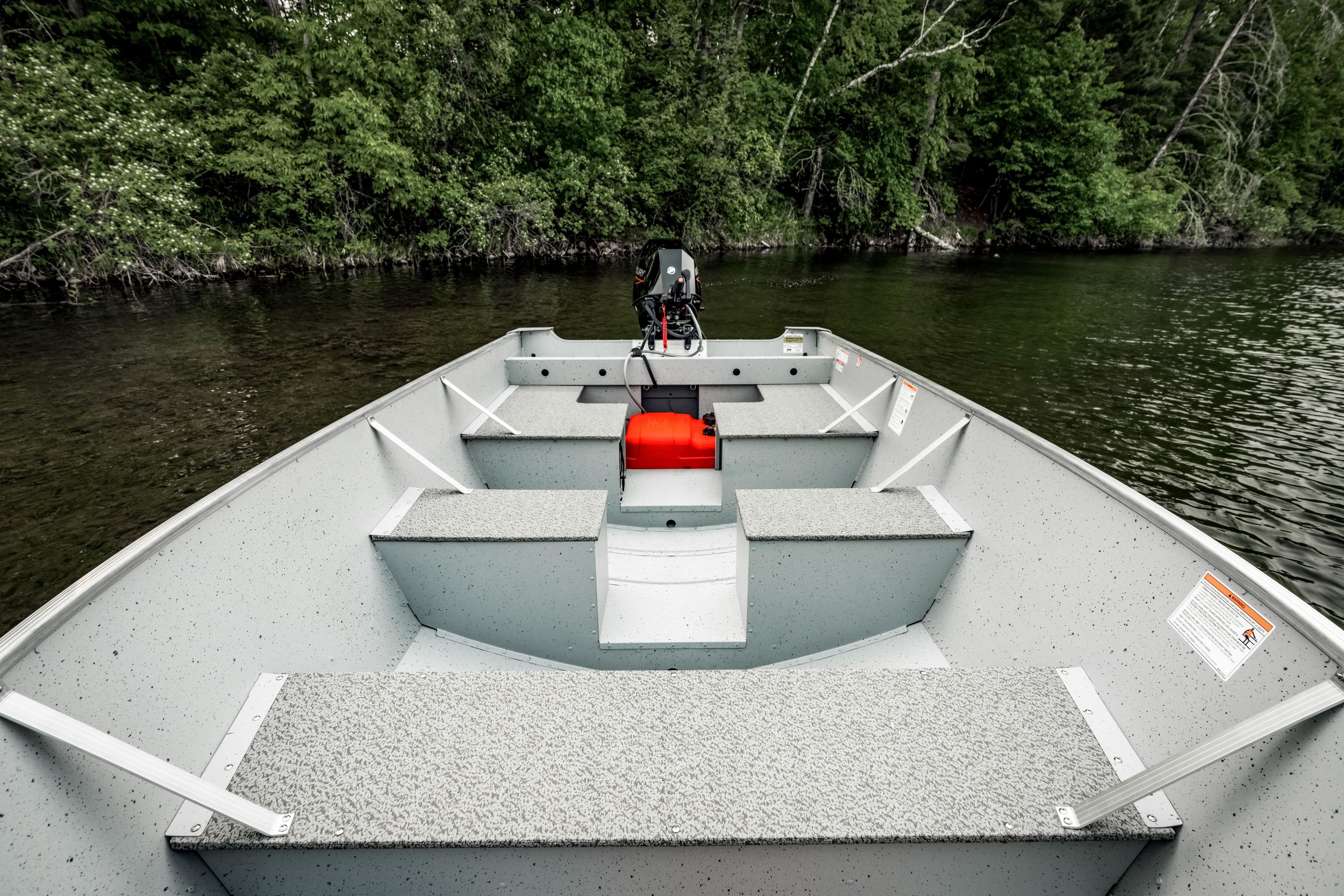 2027 Lund WC 16 boat on calm lake, surrounded by lush green trees.