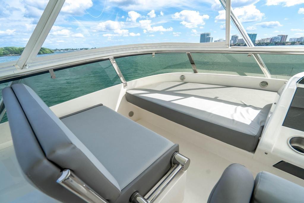 Luxurious seating area on 2020 Fairline 68 yacht with scenic ocean view.