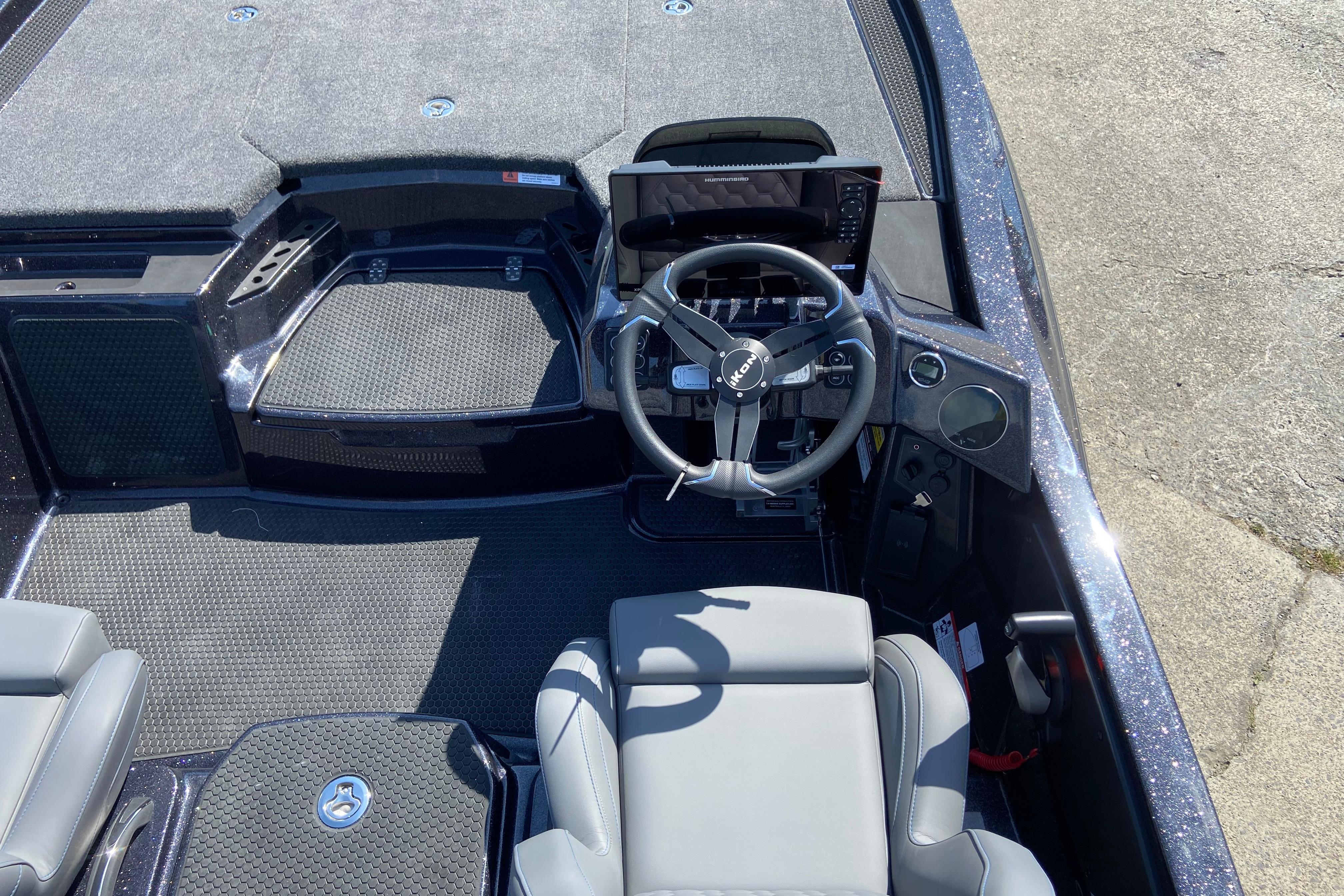 Cockpit view of 2026 iKon VLX 21 boat with steering wheel and seating.