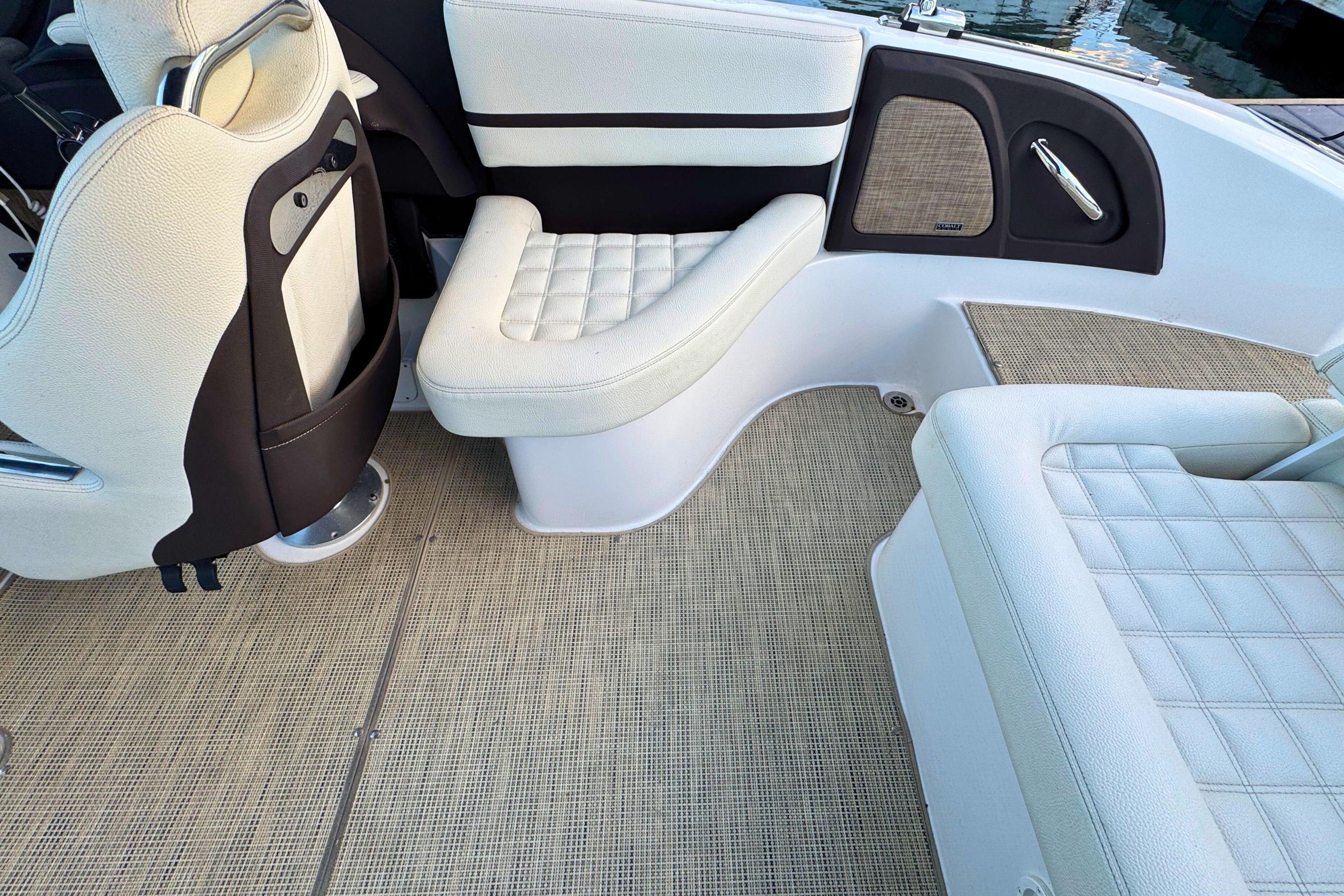 2019 Cobalt R3 boat interior with white cushioned seating and beige flooring.