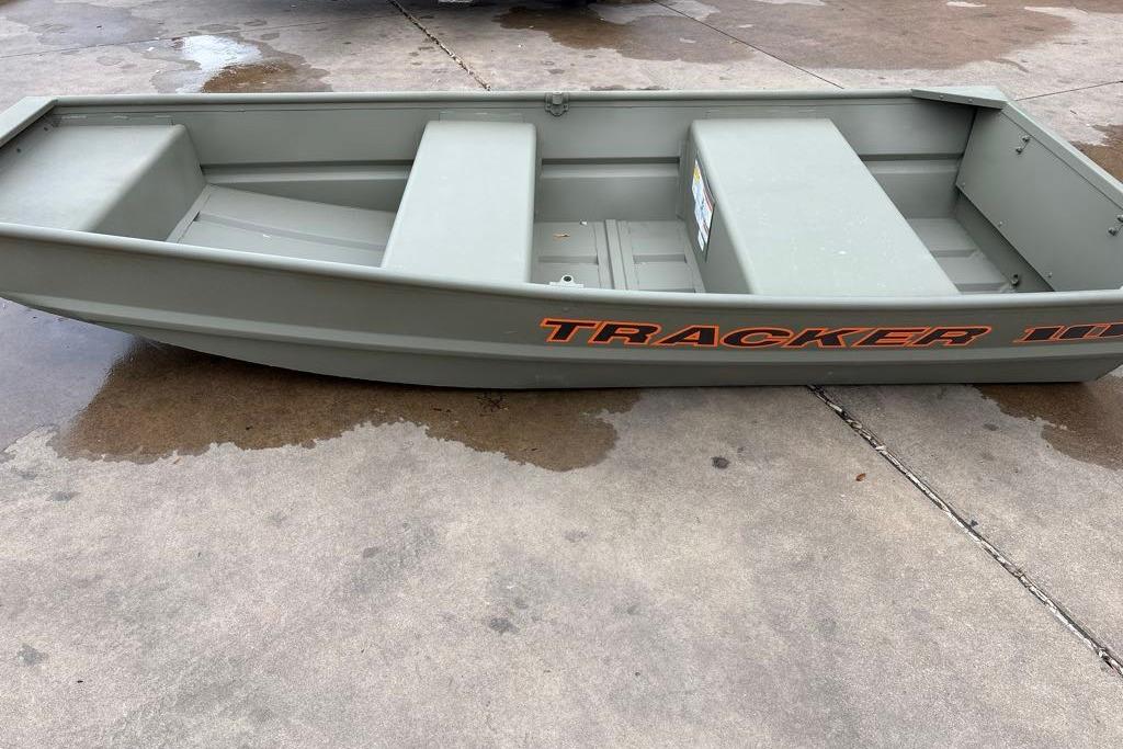 2026 Tracker Grizzly 10 Jon boat on wet concrete surface.