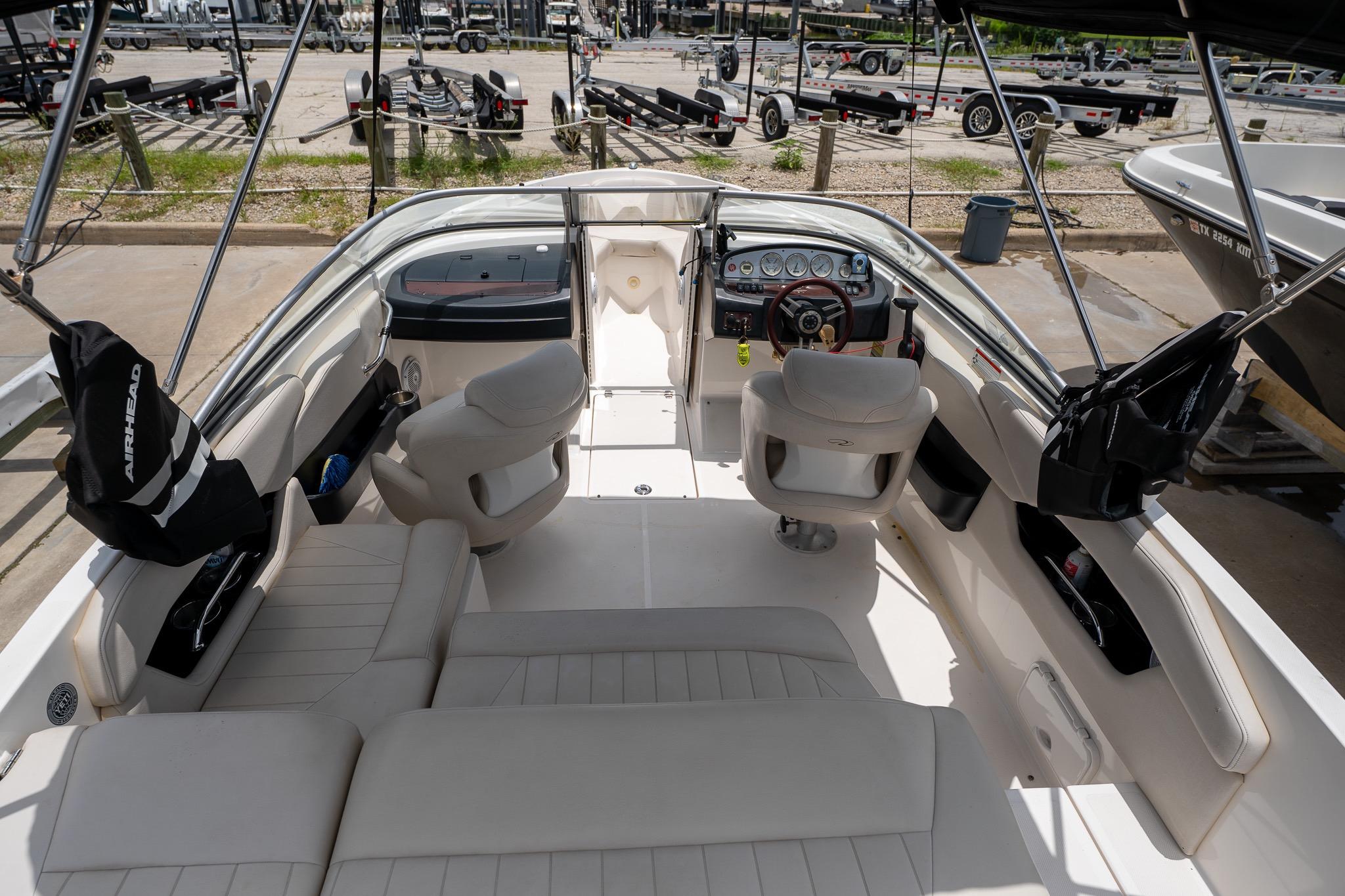 2008 Regal 2000 Bowrider boat interior with seating and dashboard, parked at marina.