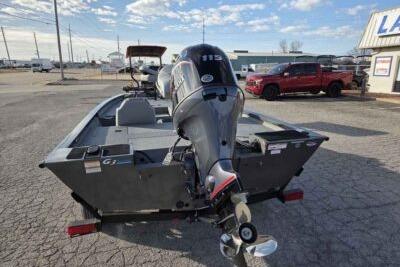 2026 G3 Sportsman 1810 PFX boat with outboard motor in parking lot.