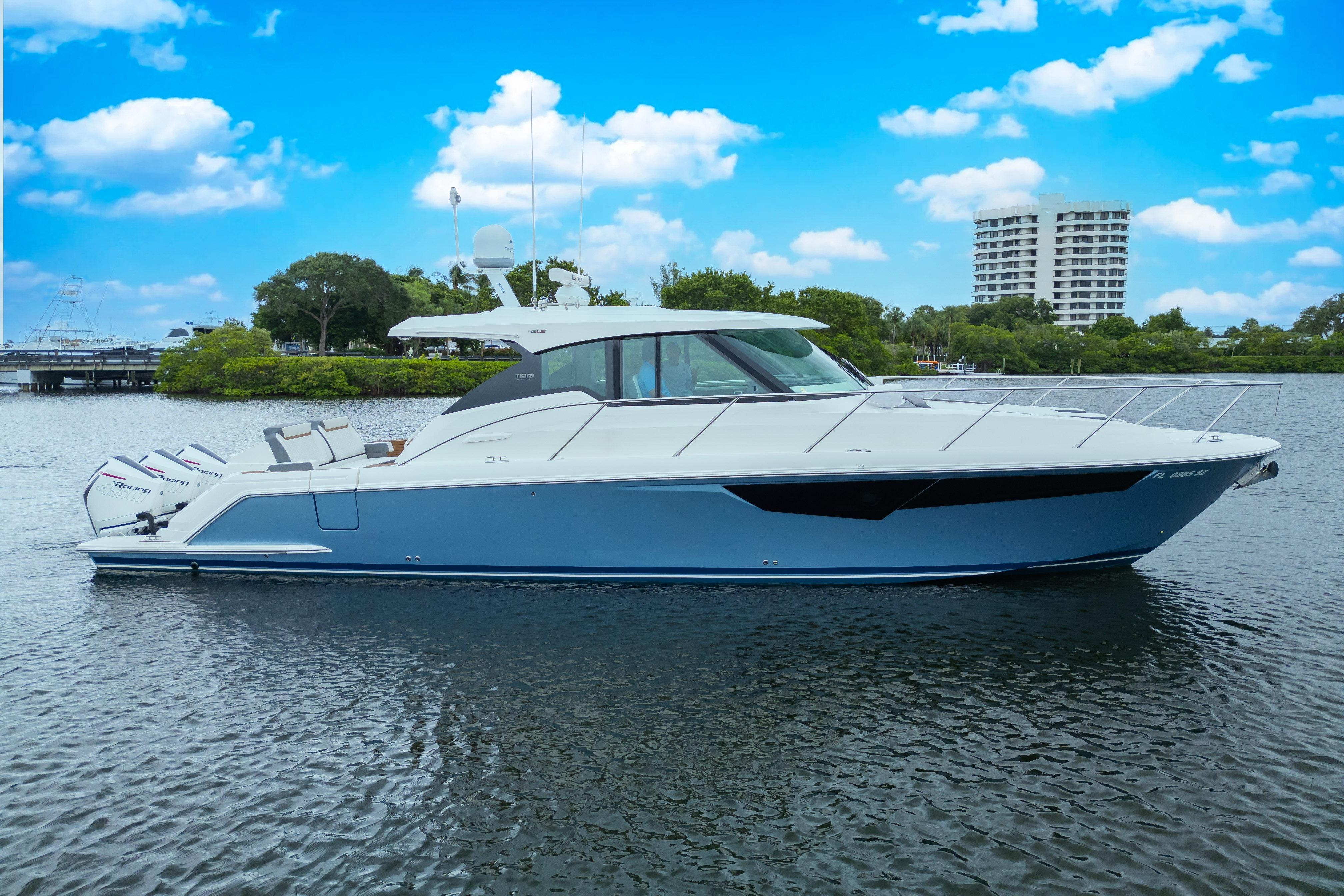 2021 Tiara Sport 43 LE boat on calm water with a clear blue sky.