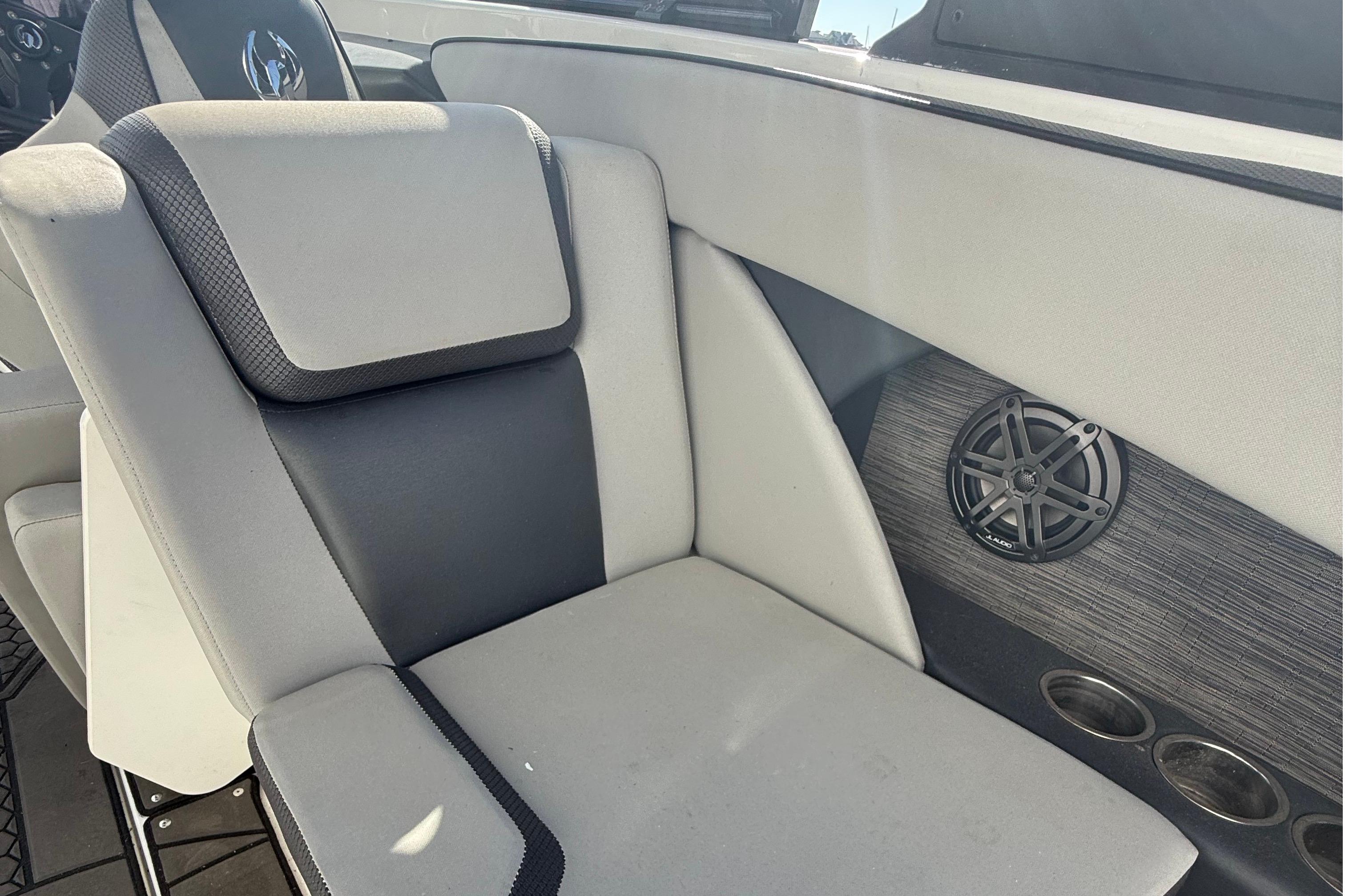 2021 Scarab 255 ID boat interior with cushioned seating and speaker system.