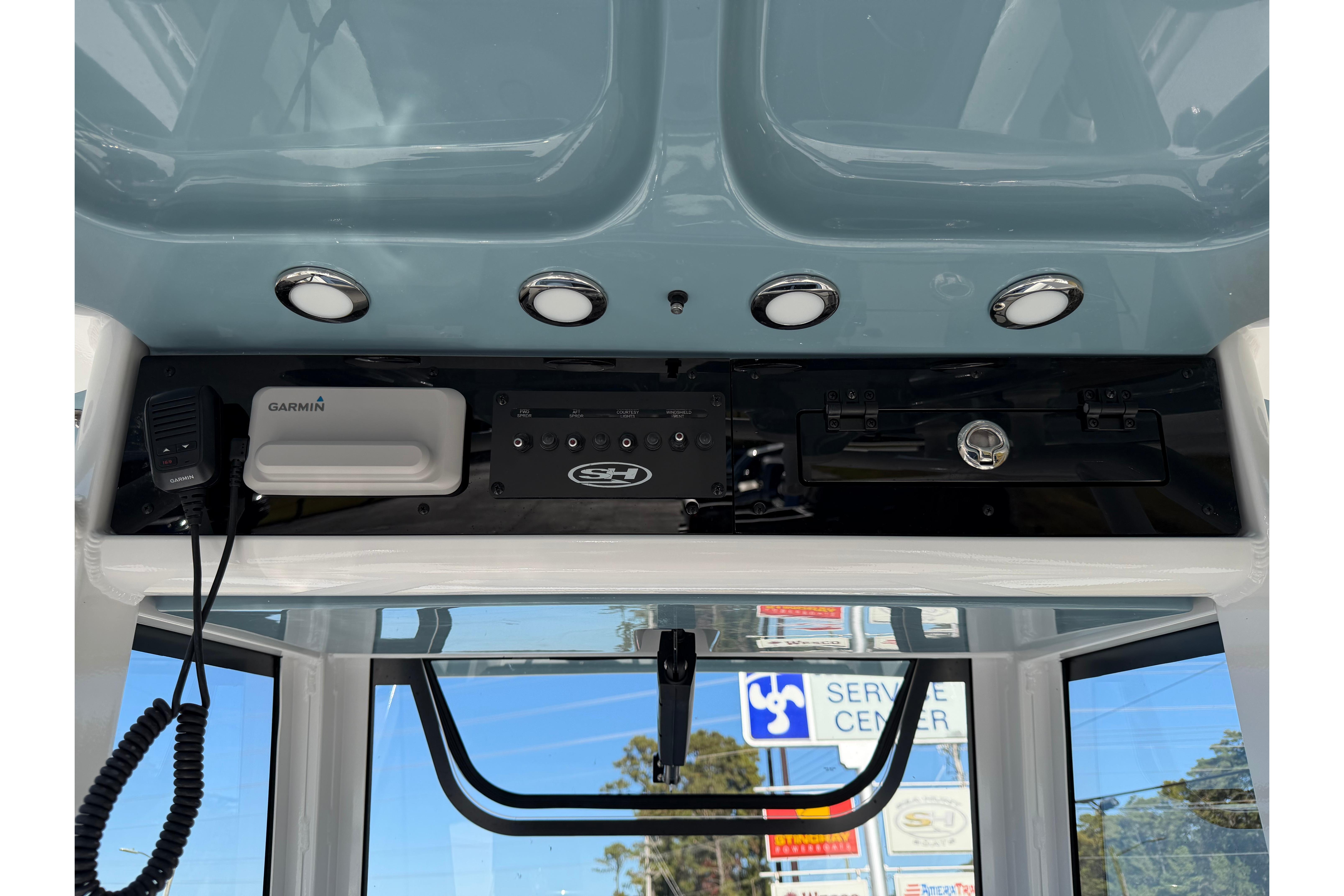 2026 Sea Hunt Ultra 275 Coffin Box dashboard with Garmin equipment and overhead lighting.