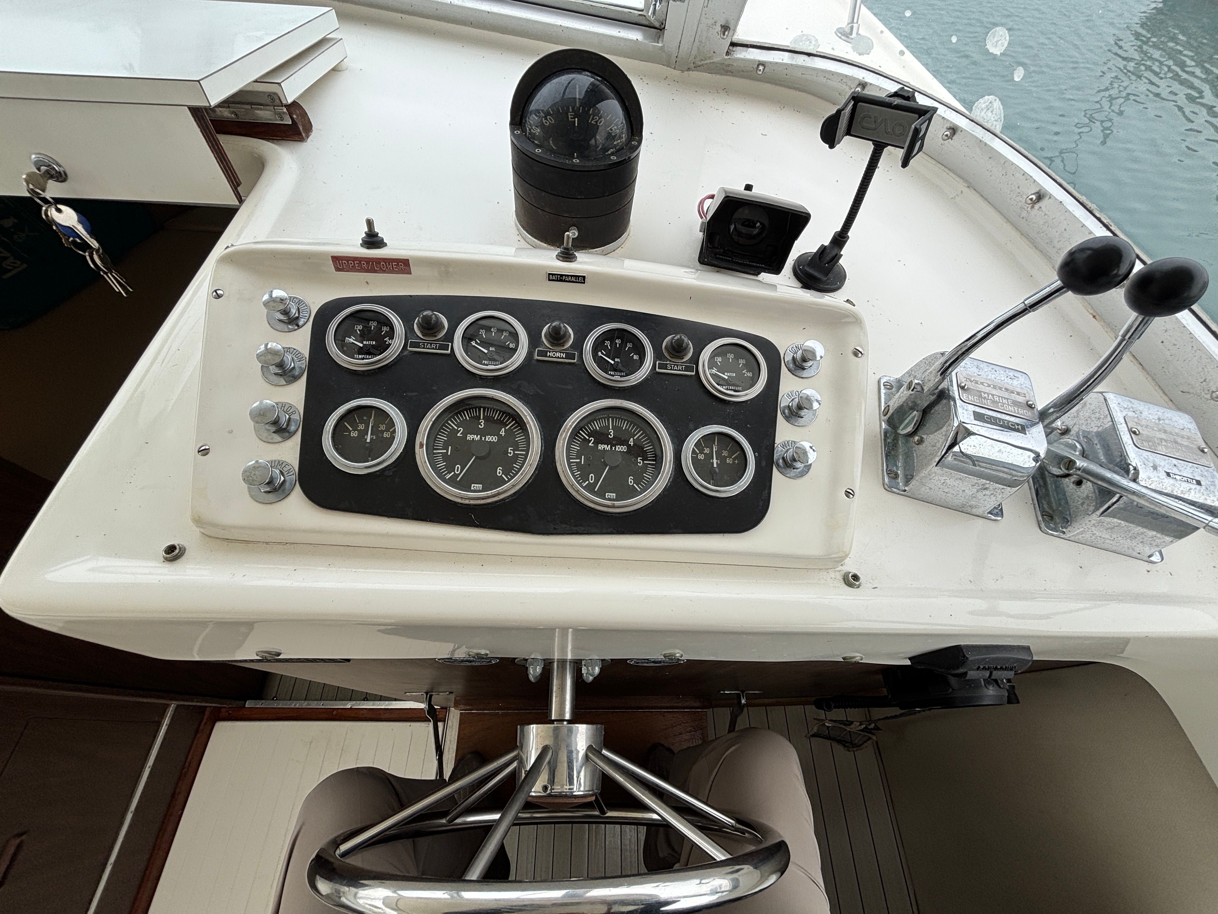 Dashboard of a 1978 Bertram MOPPIE boat with steering and instruments.