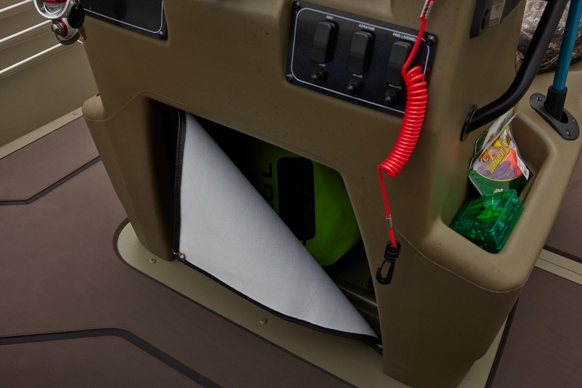 2025 Tracker Grizzly 2072 CC boat console with storage compartment and control panel.
