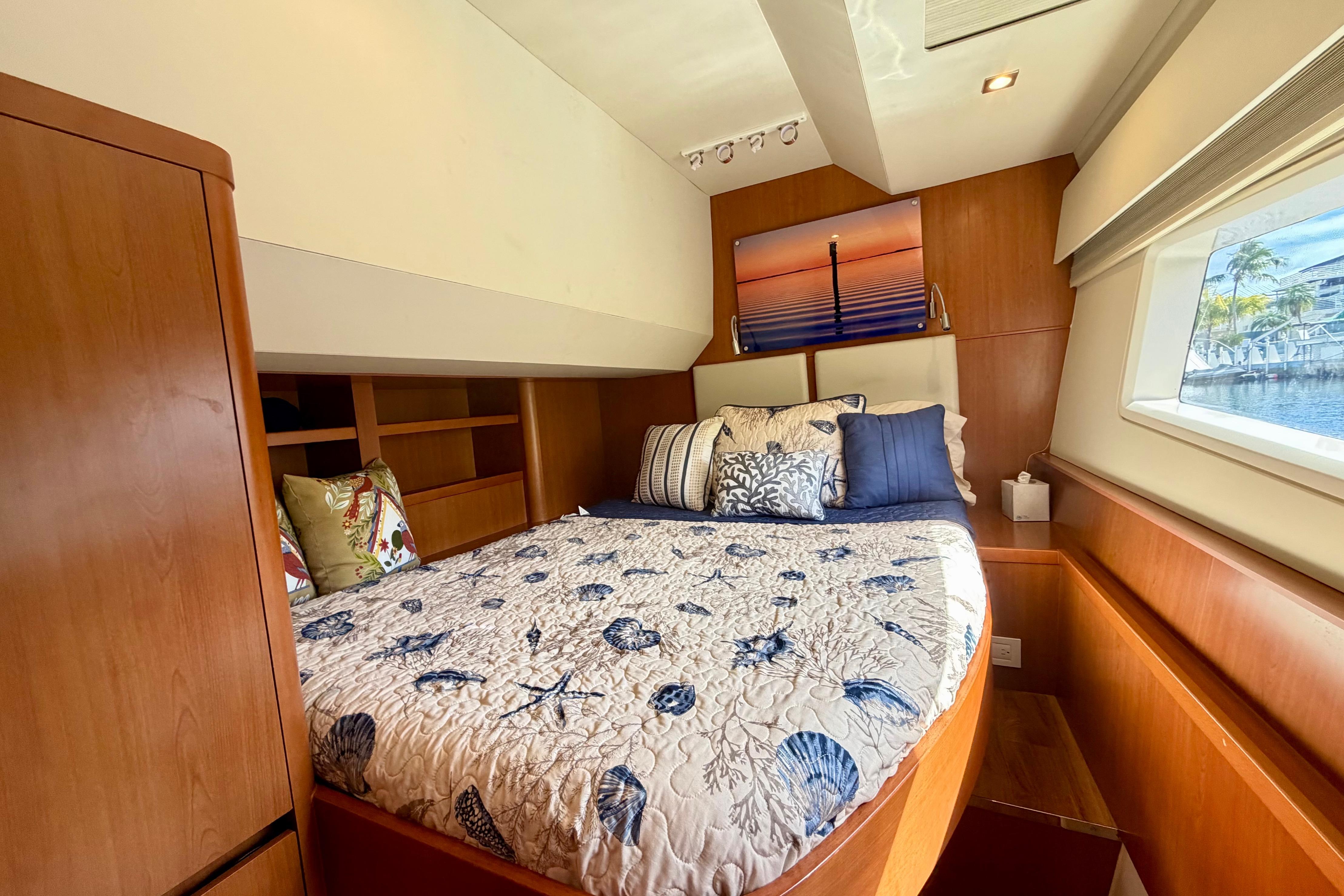 Luxurious cabin interior of 2017 Aquila 44 Yacht with nautical-themed bedding.