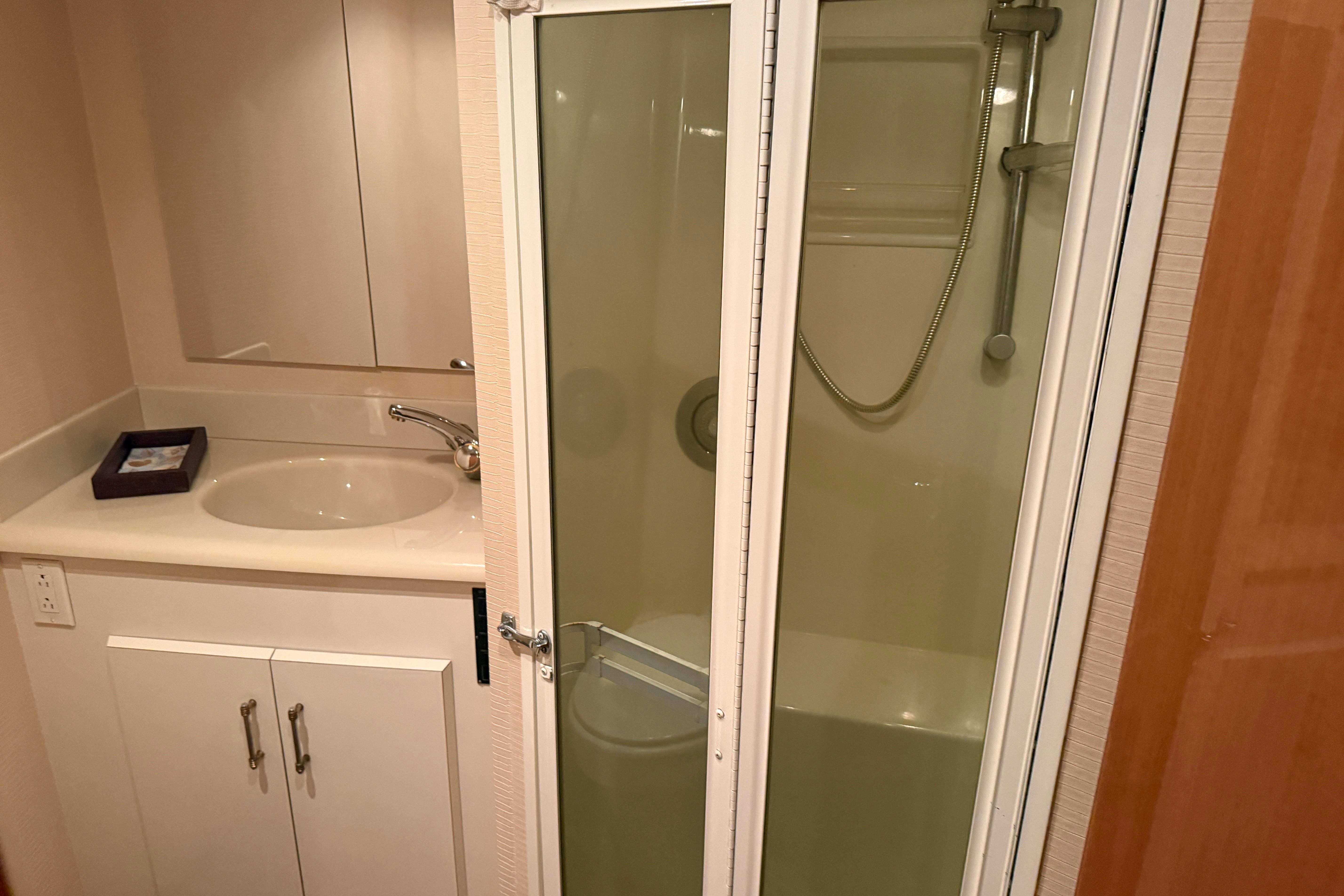 Bathroom interior of 2000 Viking 55 Convertible yacht with shower and sink.