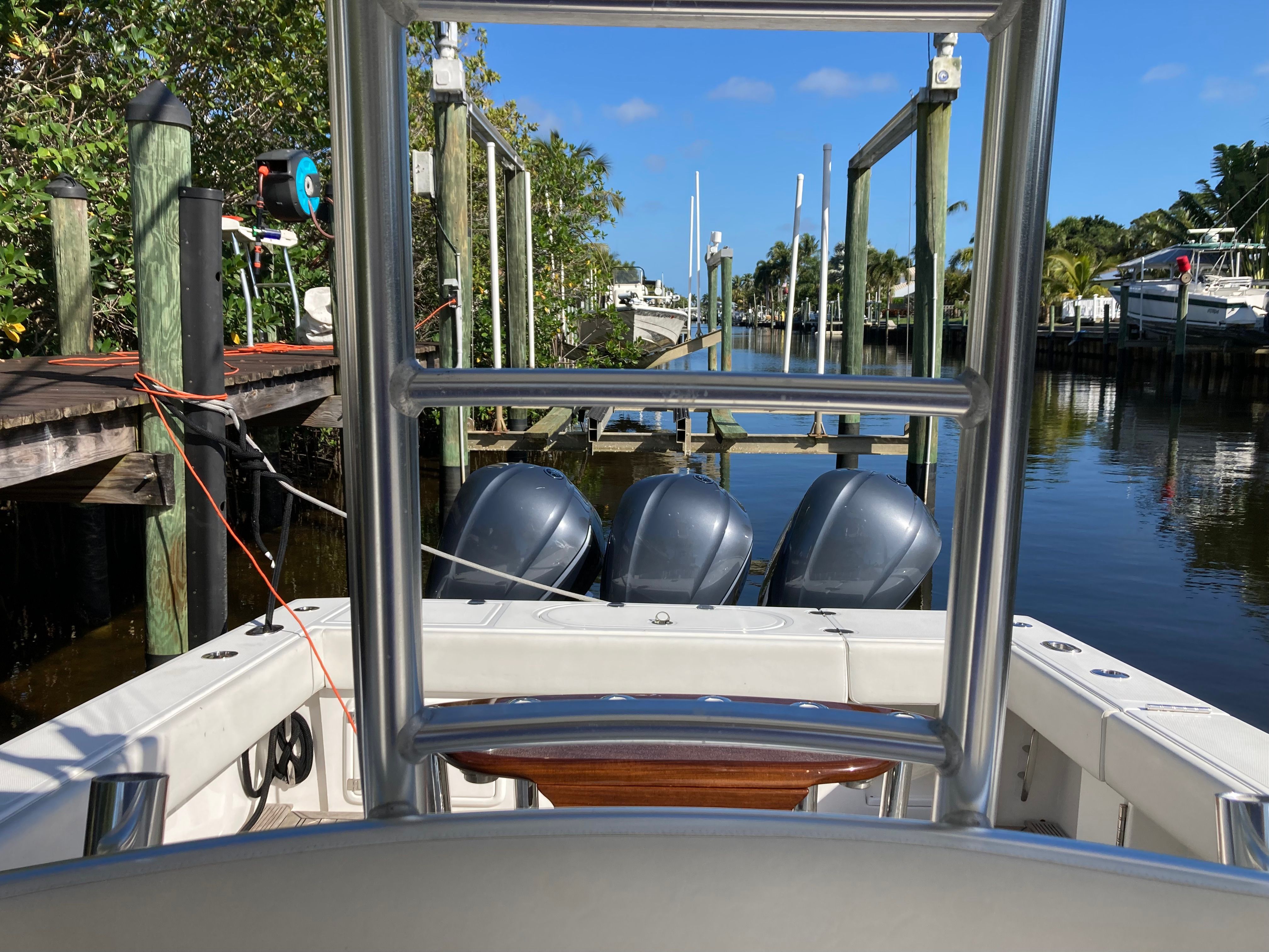 Venture CC 2019 boat at dock with three outboard motors.