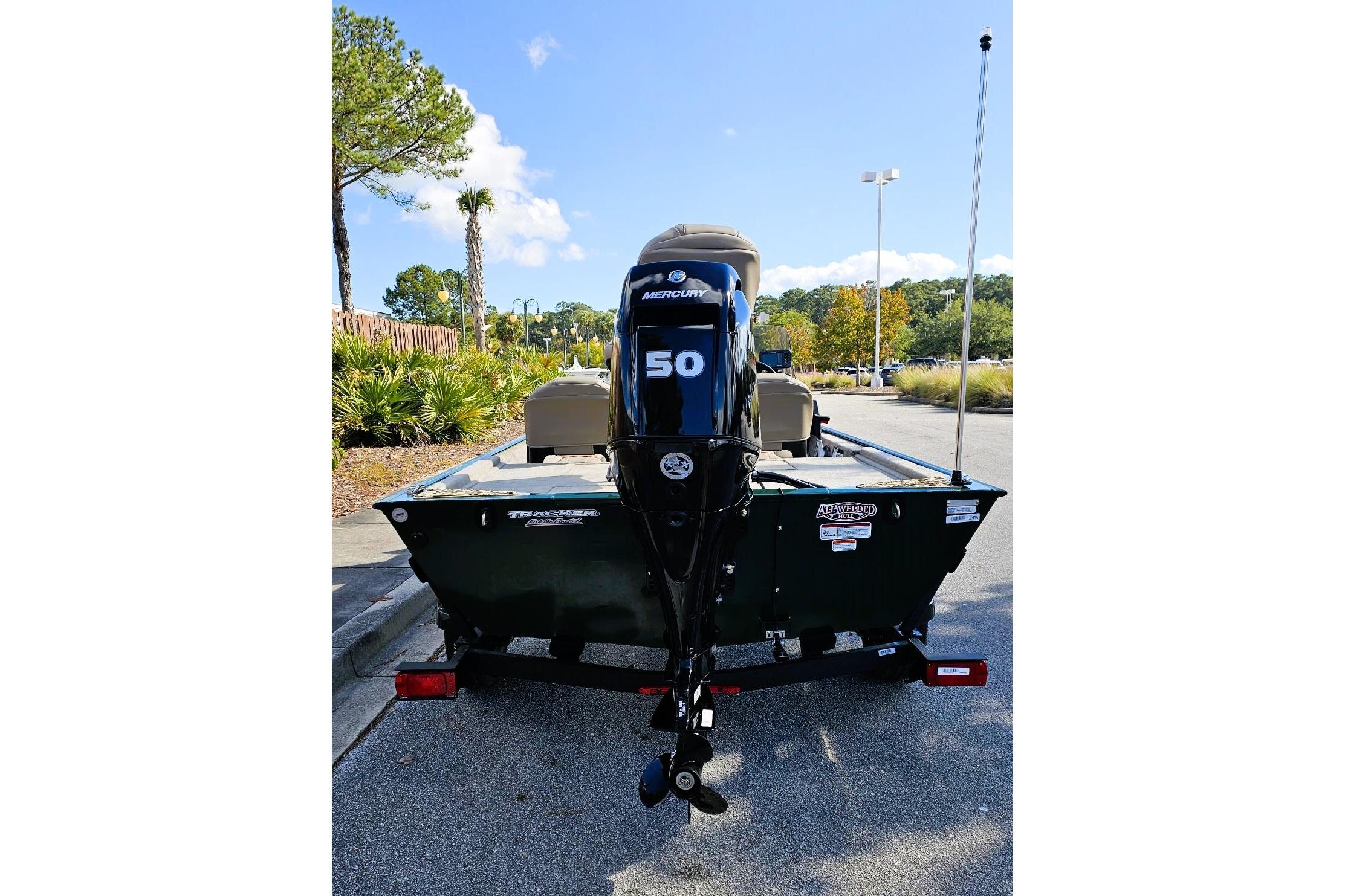 2026 Tracker Bass Tracker Classic Limited boat with Mercury 50 engine in parking lot.