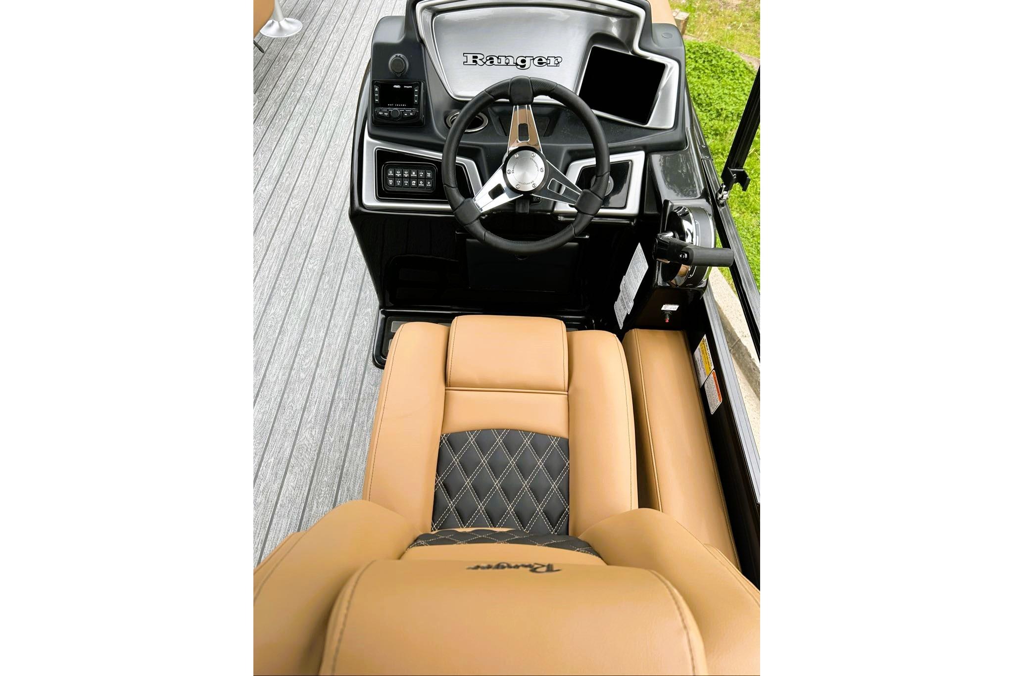 2026 Ranger 220FC boat interior with tan leather seats and modern steering console.