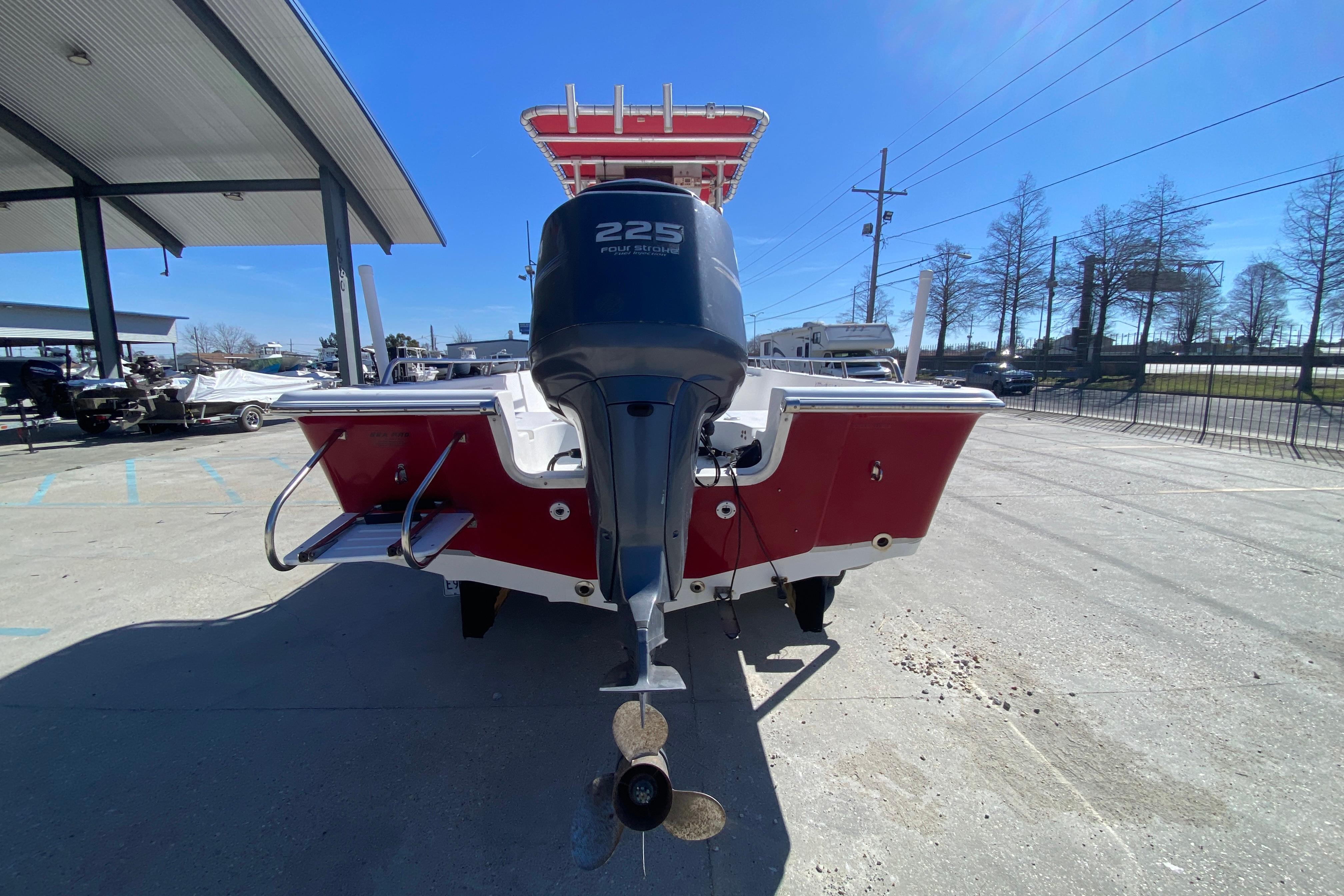 2005 Sea Pro SV2400CC Bay Boat with outboard motor, parked outdoors.