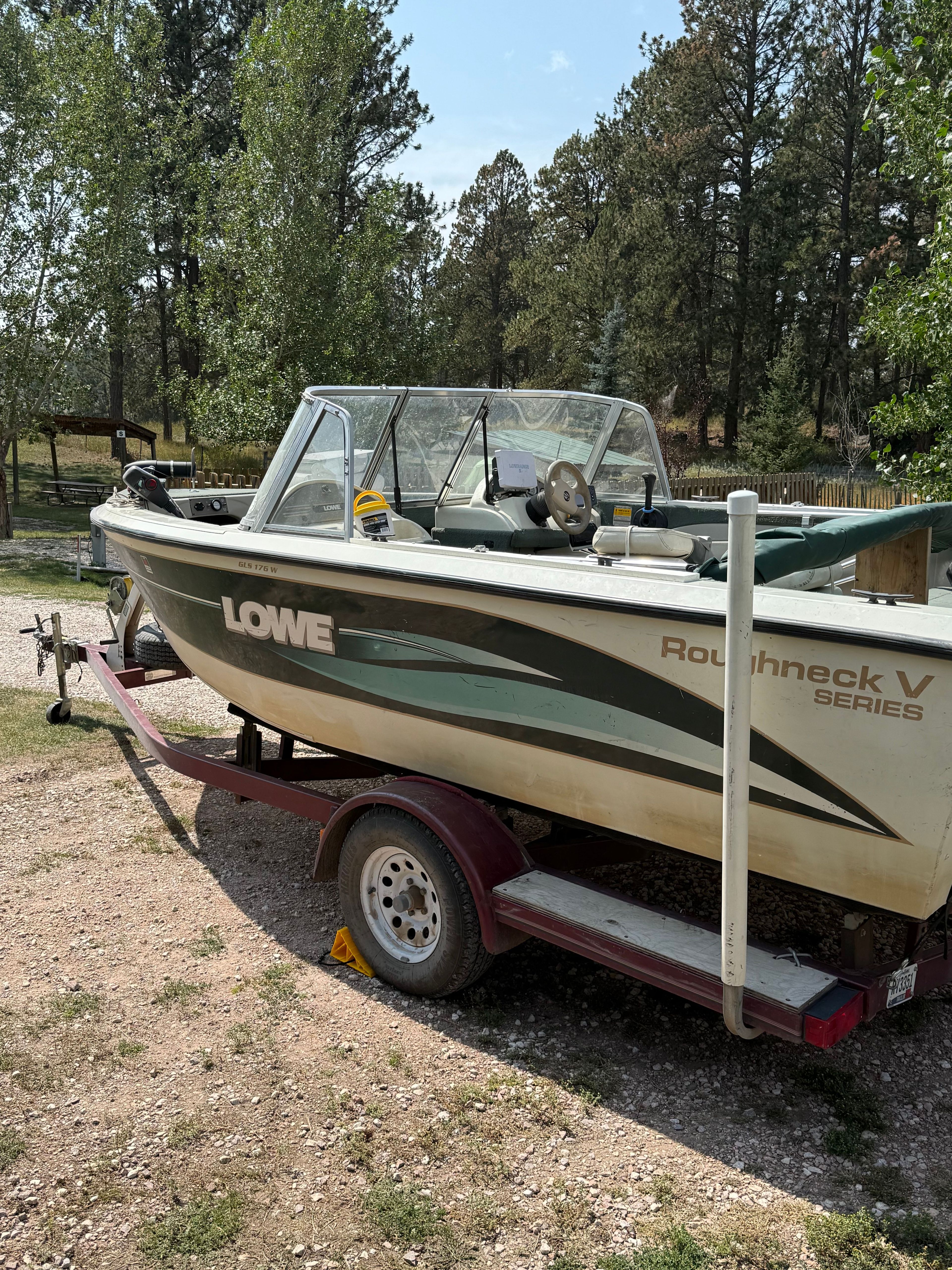 1999 Lowe Roughneck boat on trailer in forest setting.