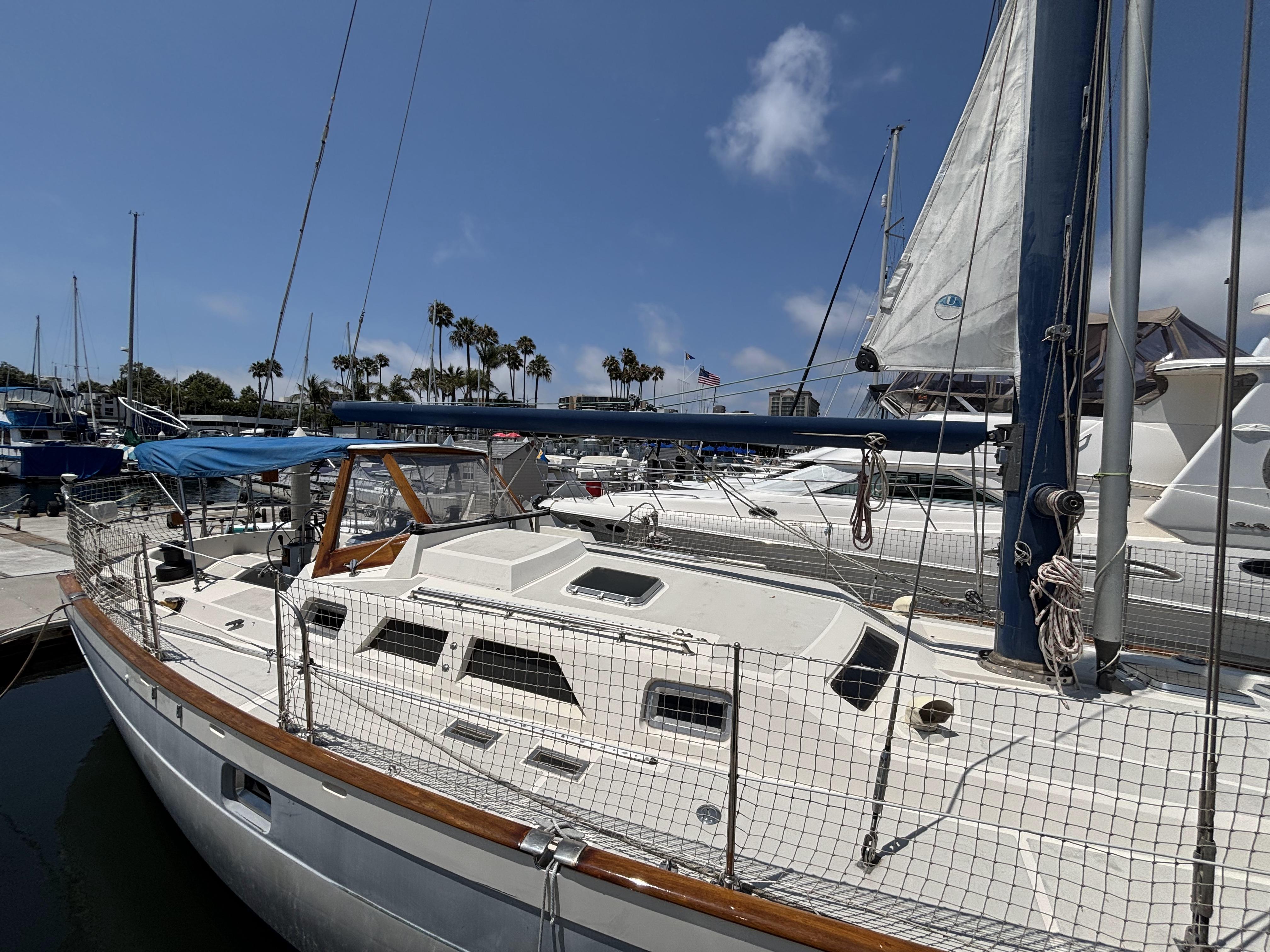 1982 Norseman 447 sailboat docked at marina under clear blue sky.