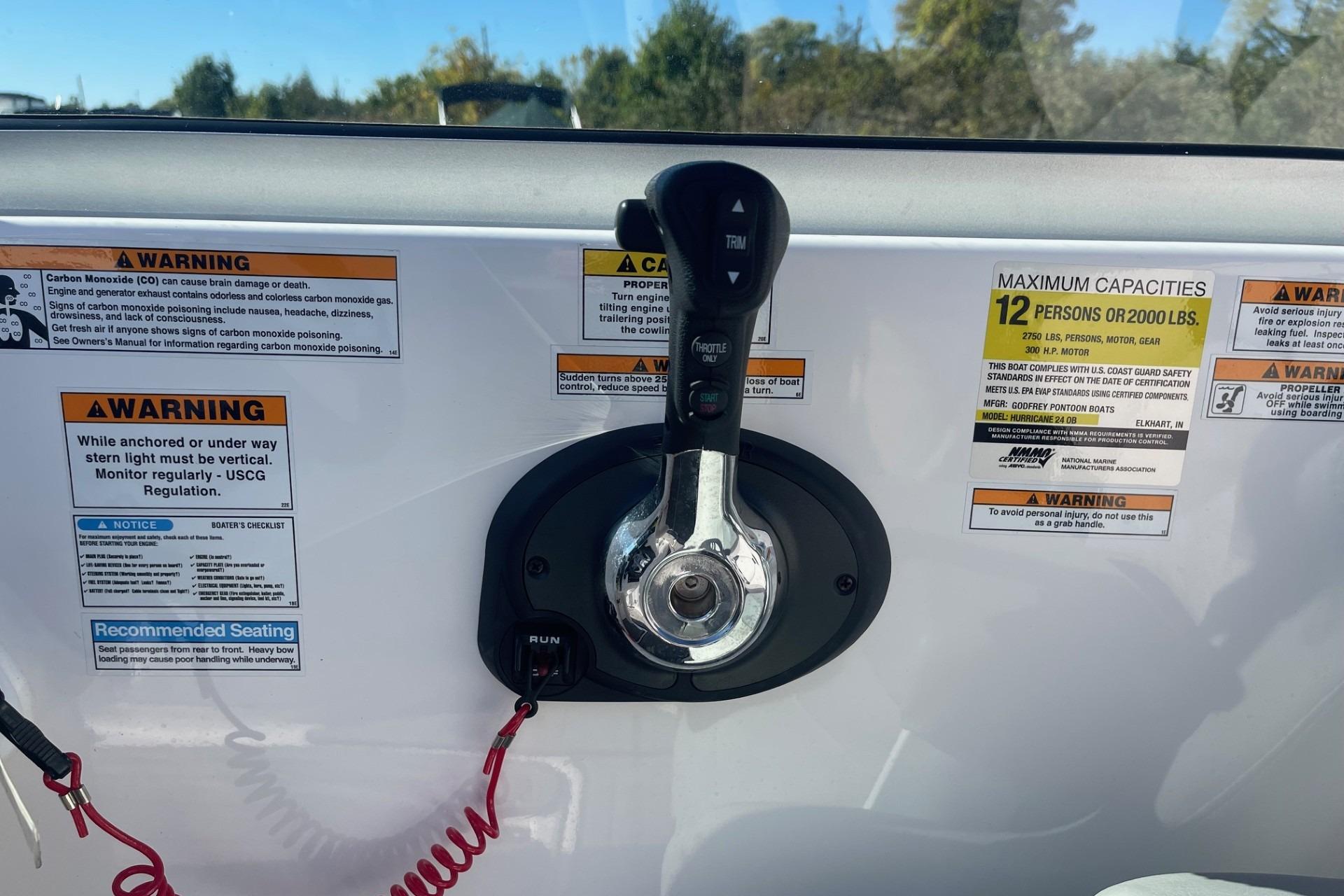 Control panel of 2023 Hurricane SunDeck 2400 OB with safety warnings and capacity details.