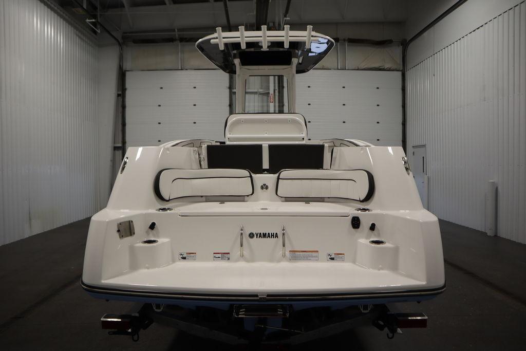 2026 Yamaha Boats 255 FSH Sport E, rear view in a spacious indoor setting.
