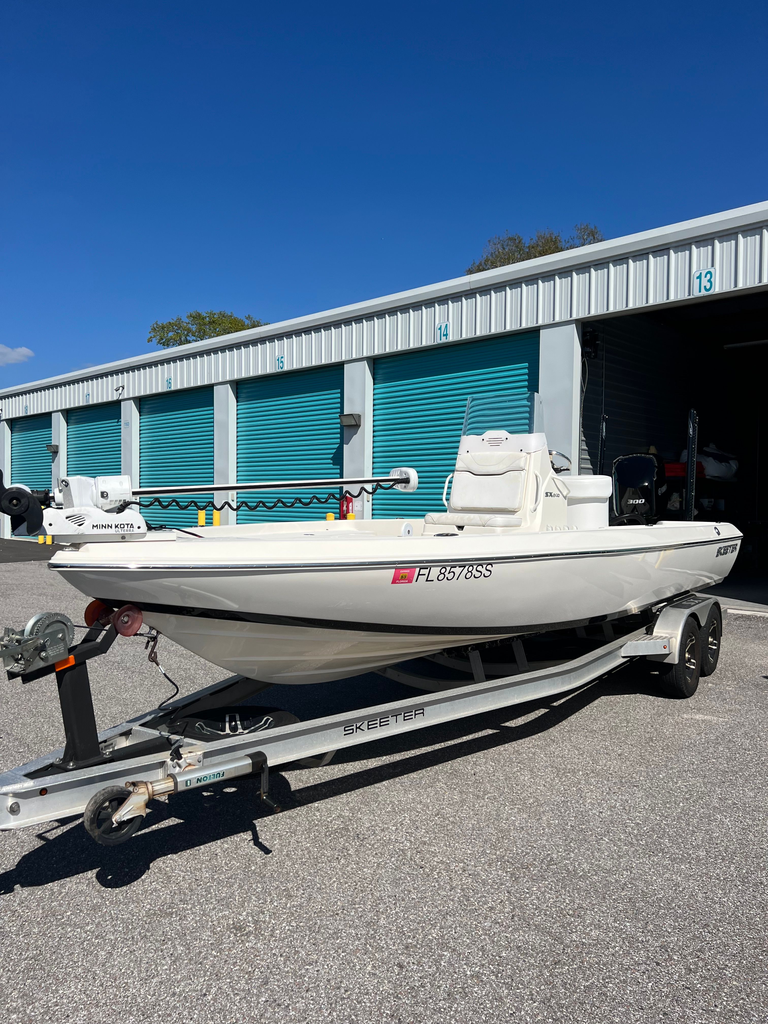 A 2020 Skeeter SX240 boat on a trailer in front of storage units.