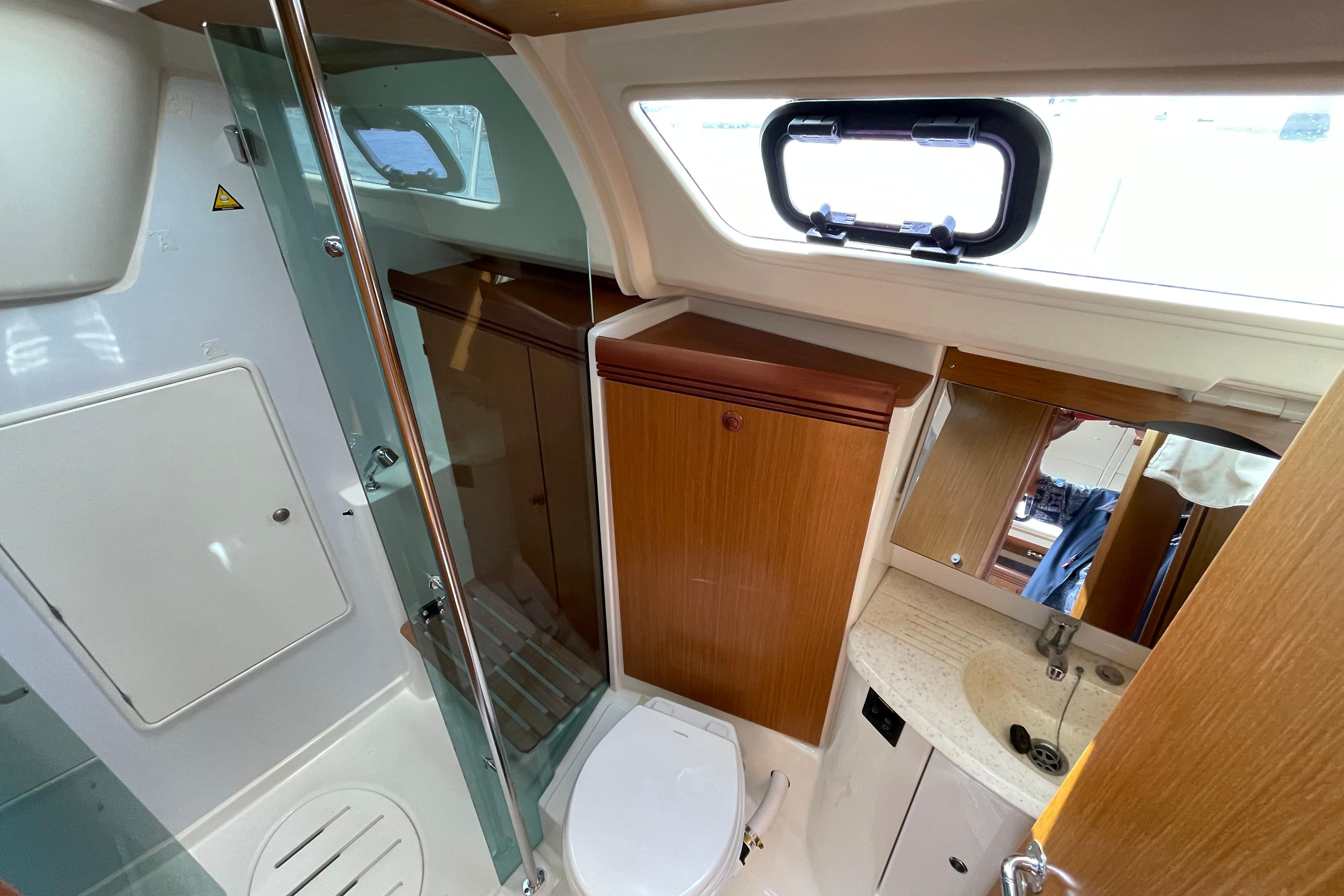 Bathroom interior of 2007 Jeanneau Sun Odyssey 39 DS yacht, featuring shower and sink.