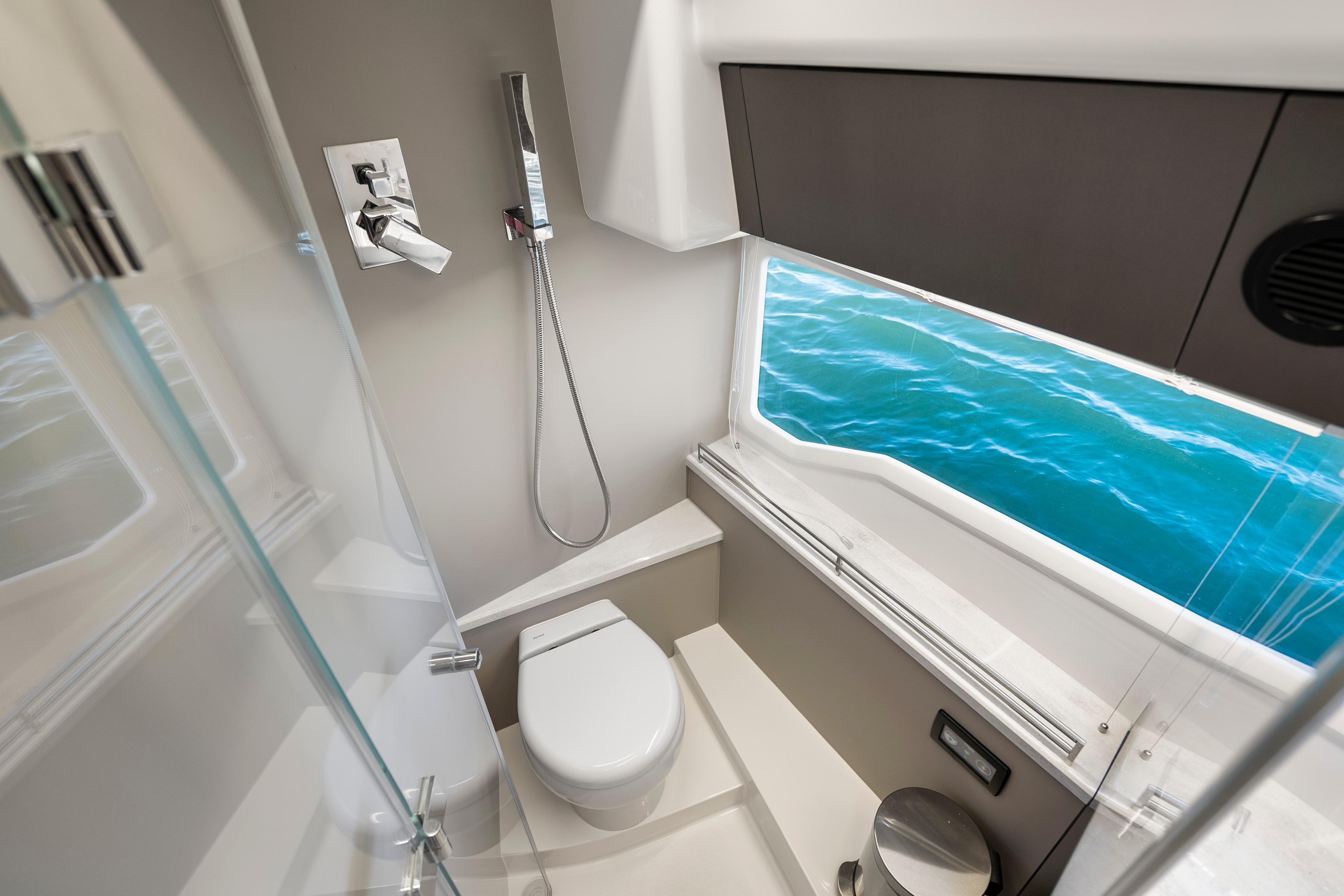 Luxurious bathroom on 2023 Galeon 400 Fly yacht with ocean view window.
