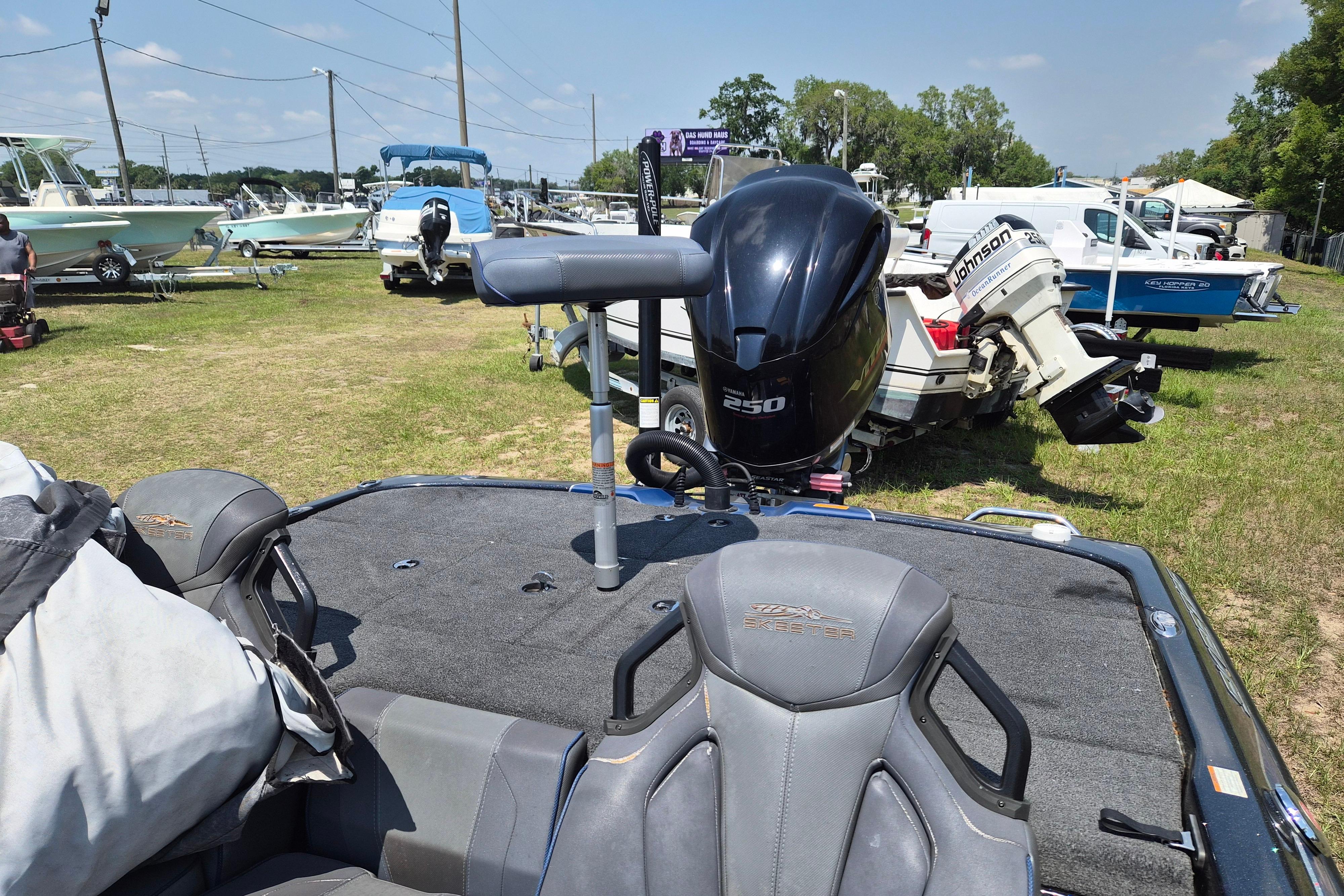 2021 Skeeter ZXR20 boat with powerful 250 engine, parked outdoors among other boats.