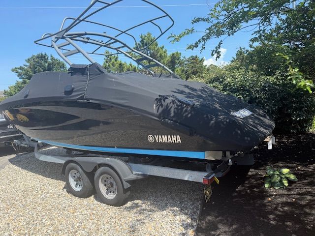 Yamaha 252SE boat 2021 on trailer, covered, parked outdoors.