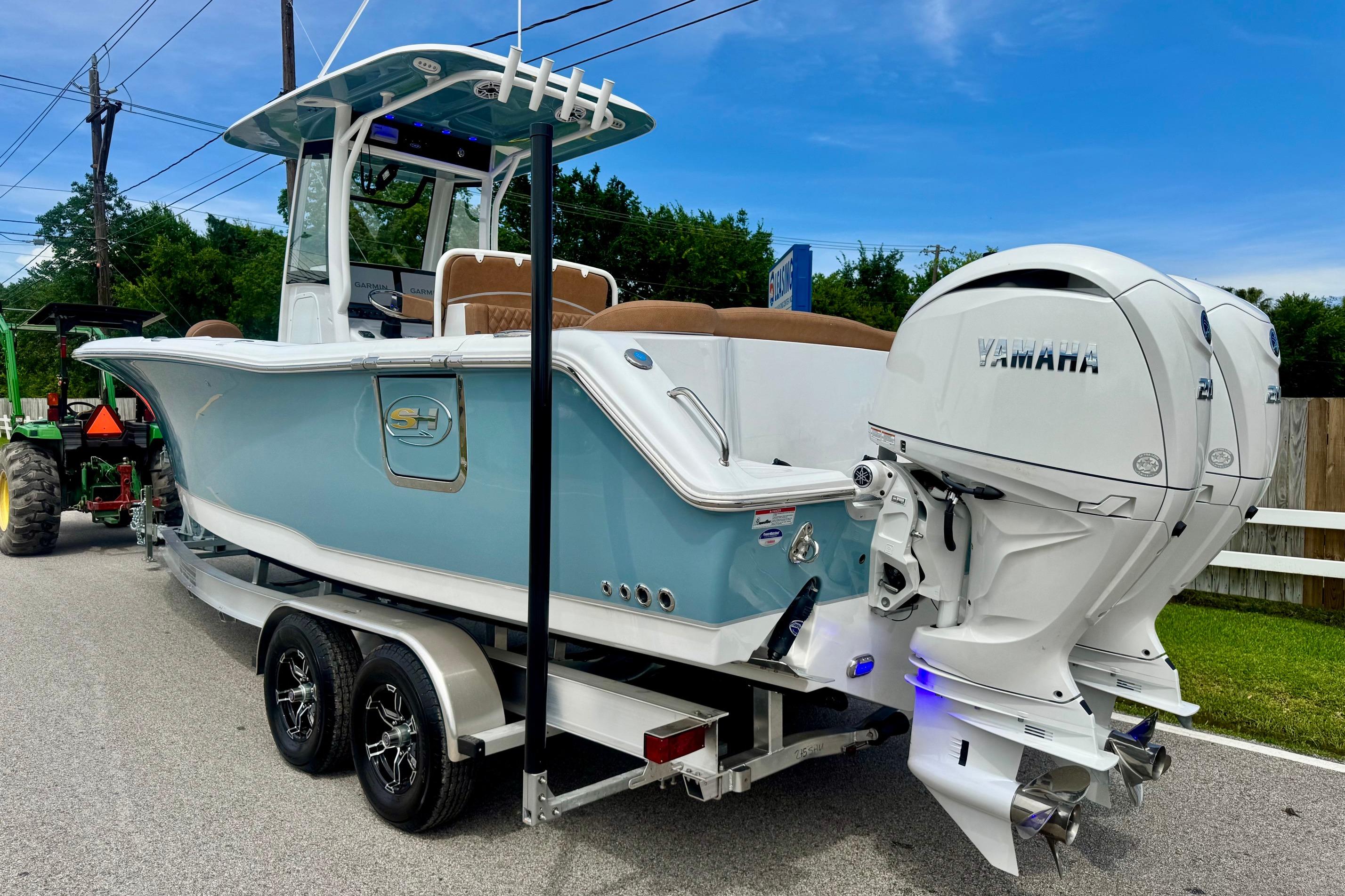 2026 Sea Hunt Ultra 275 SE boat with dual Yamaha engines on a trailer.