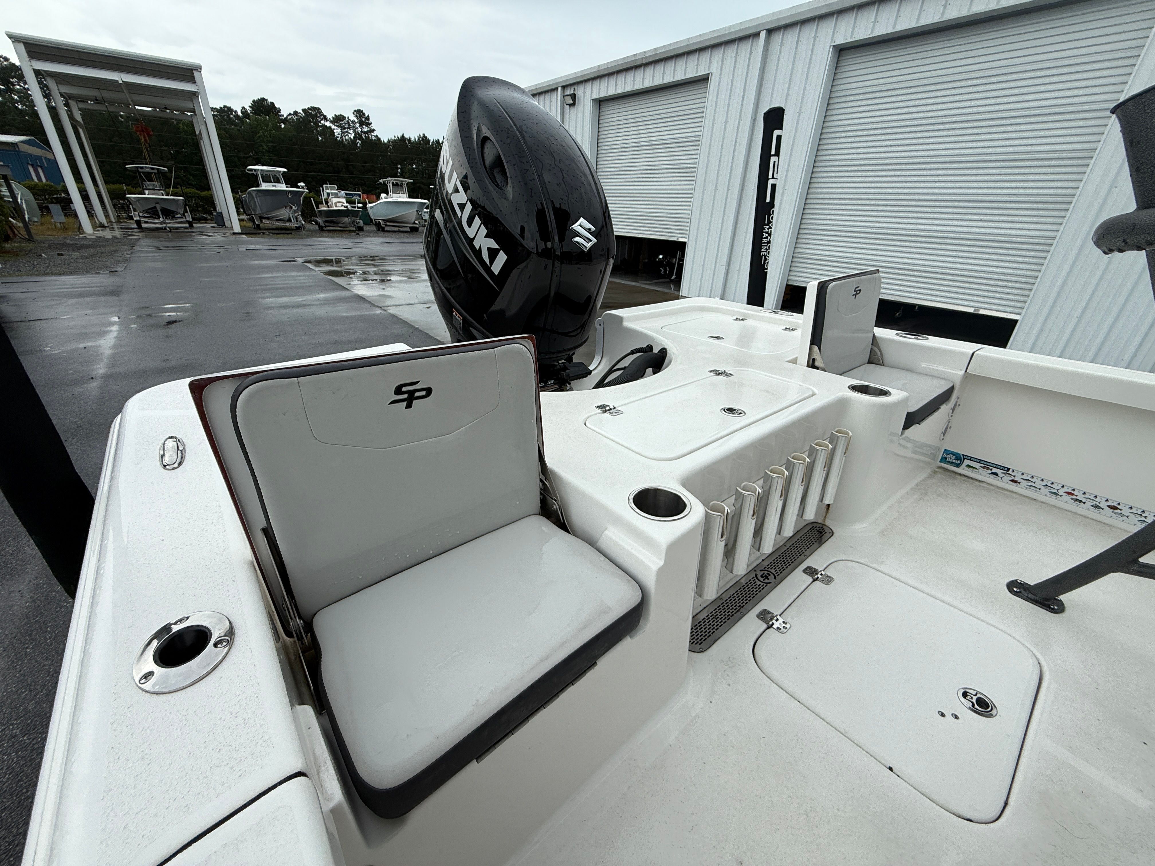The image shows the stern of a Sea Pro 230 DLX boat with a Suzuki outboard motor.