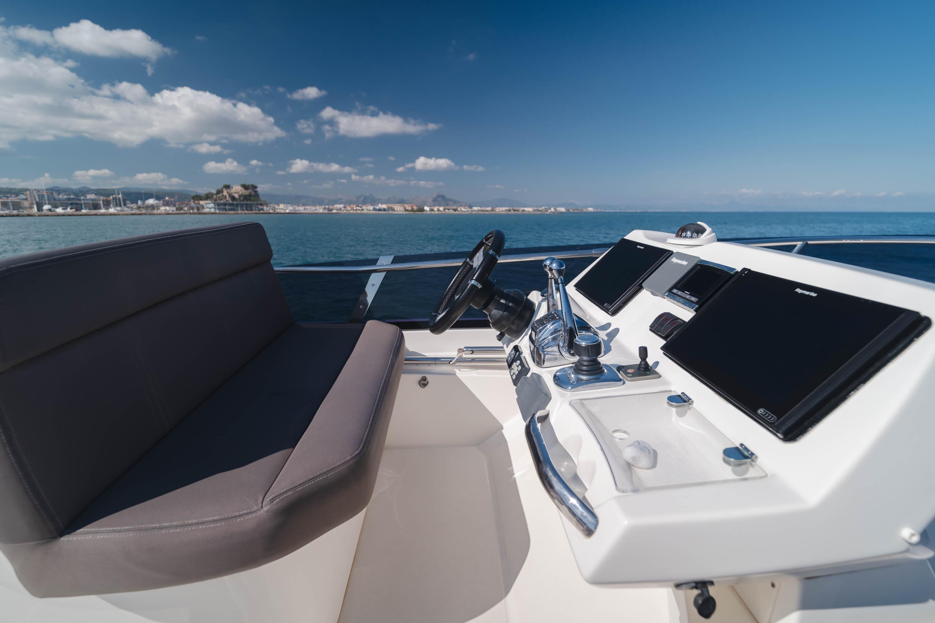 Cockpit of 2017 Prestige 560 yacht with modern controls and ocean view.