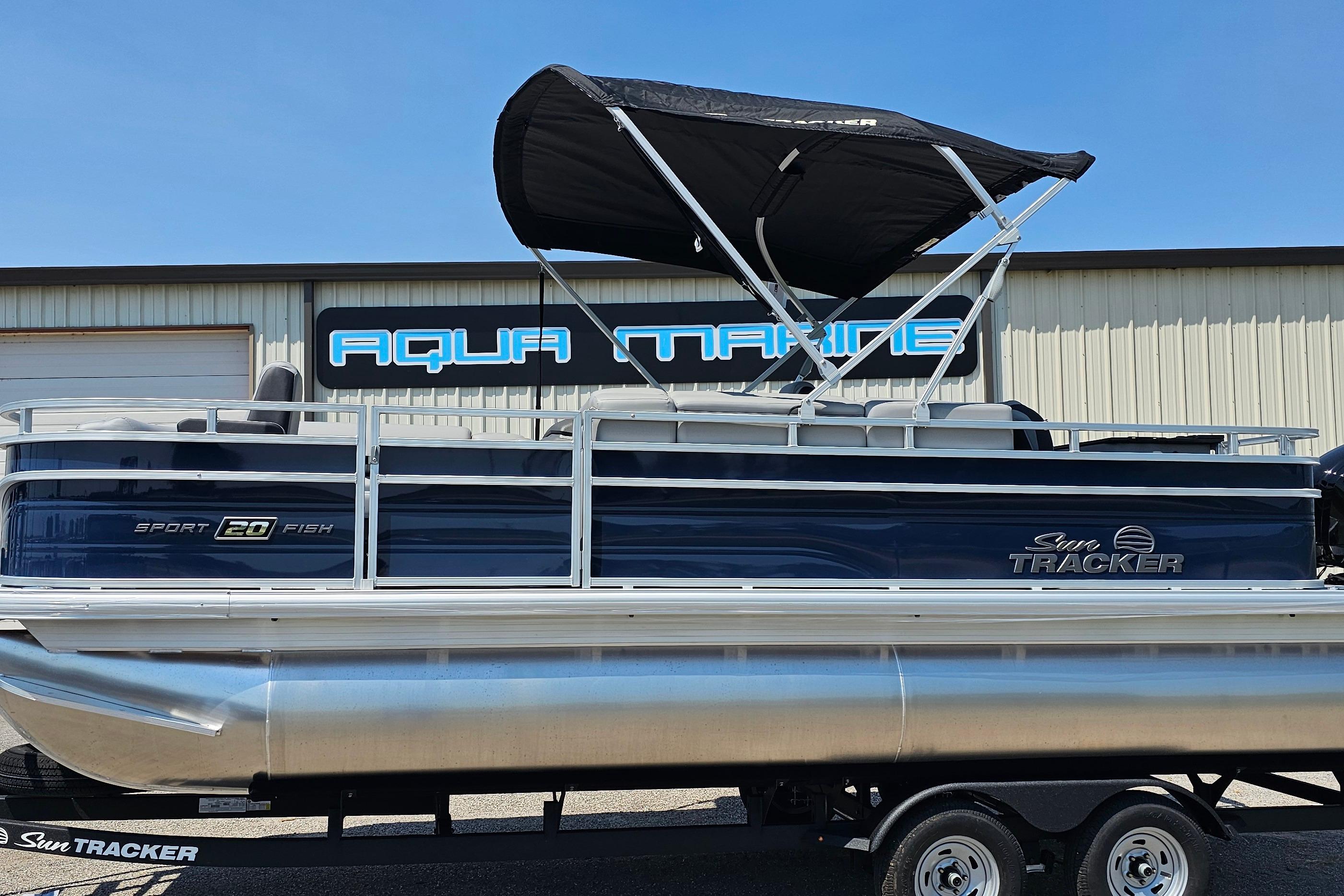 2026 Sun Tracker SportFish 20 DLX pontoon boat with canopy at Aqua Marine dealership.