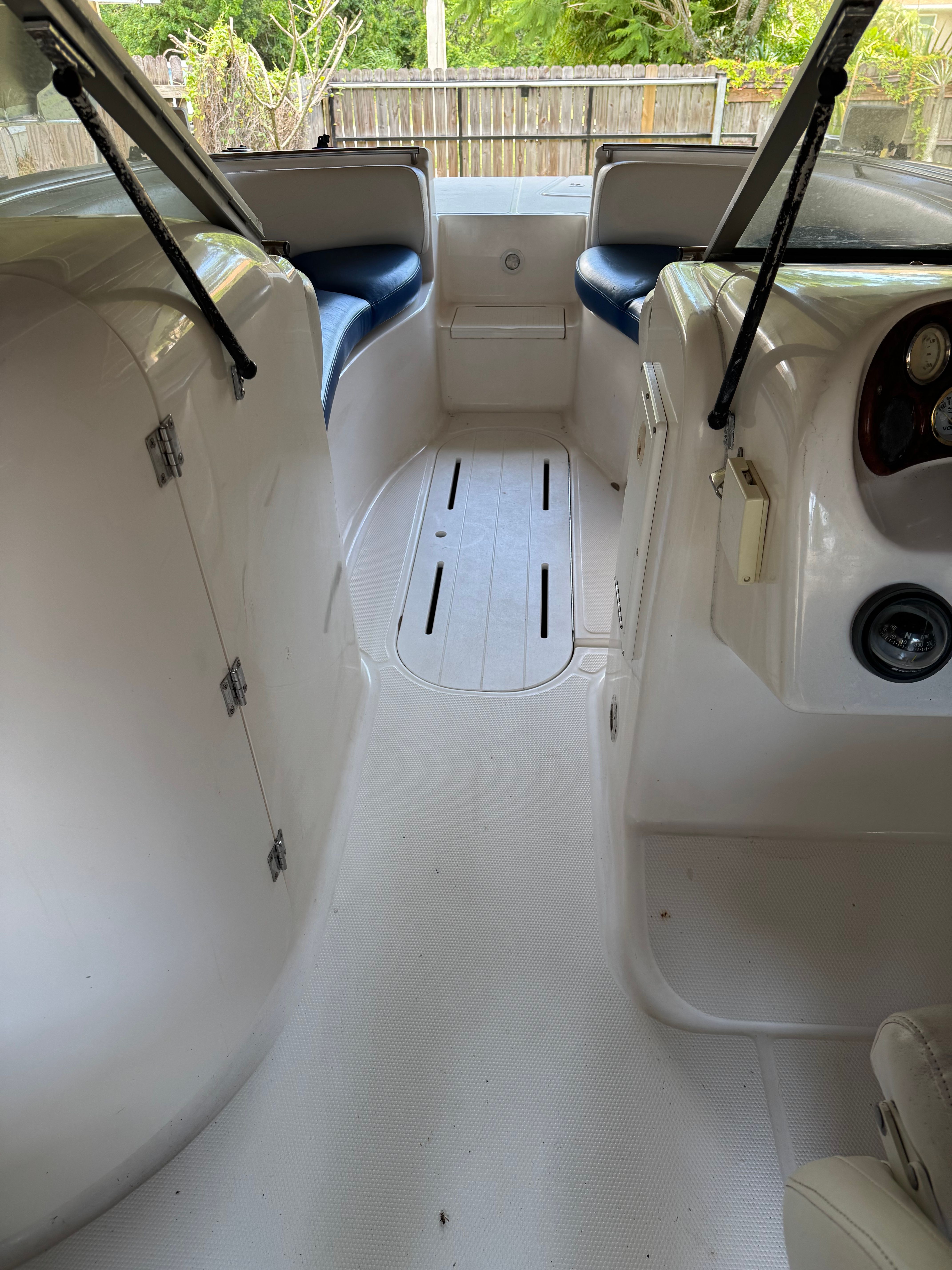 Interior of a 2004 Custom DB212 boat with white seating and dashboard.