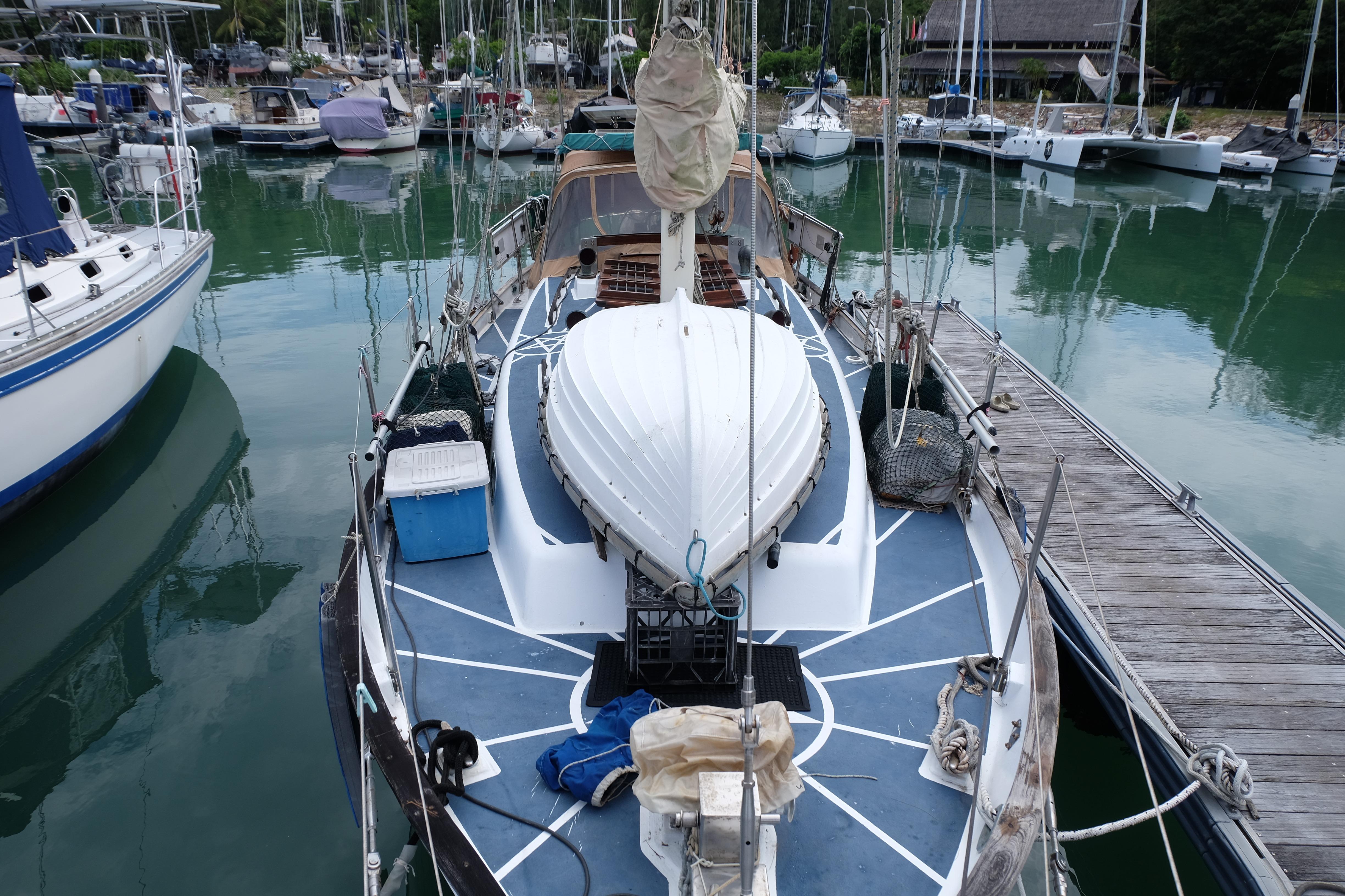 1979 Westwind 35 sailboat docked in a marina, surrounded by calm water and other boats.