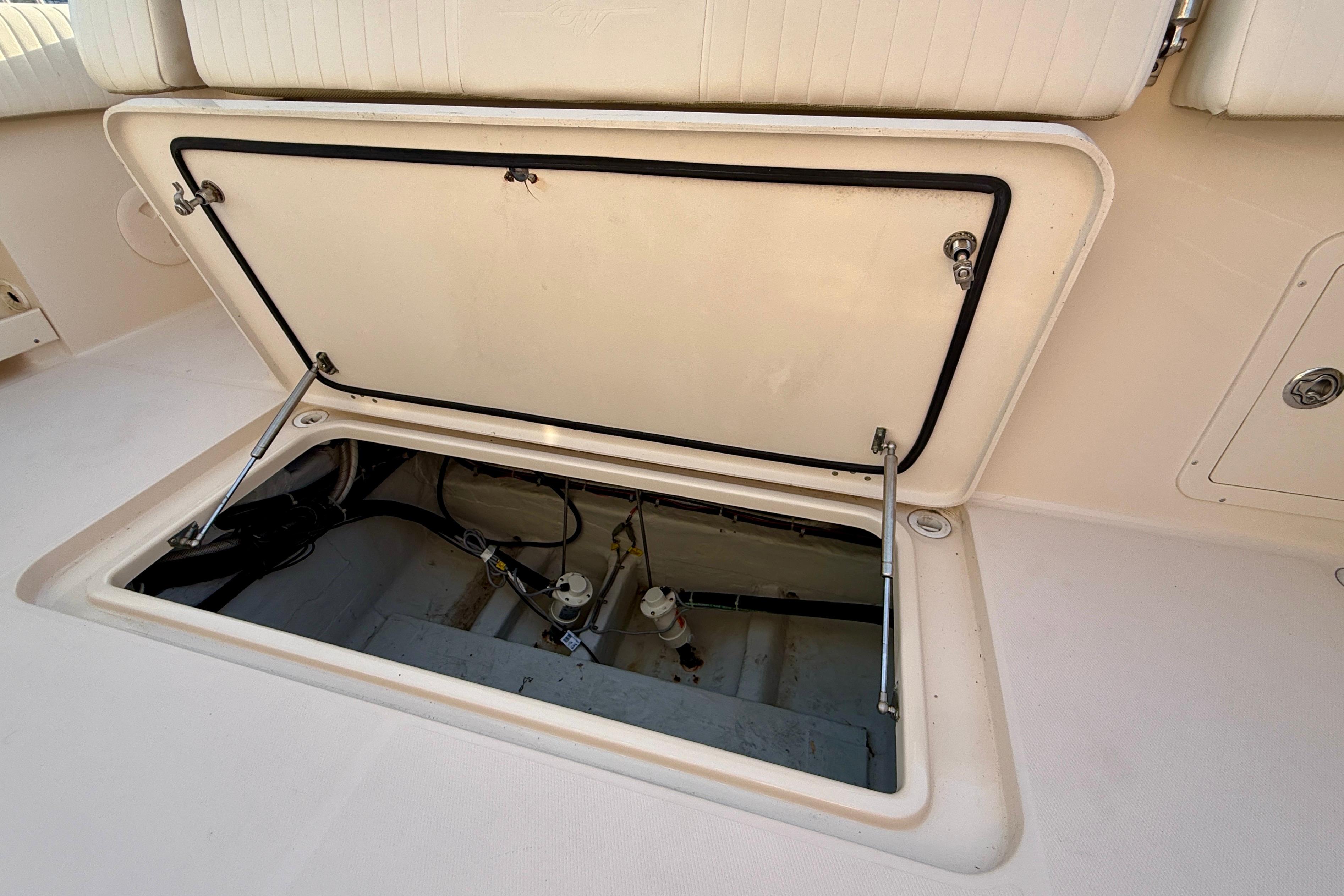 Open hatch on 2012 Grady-White Canyon 336 boat deck, revealing interior components.